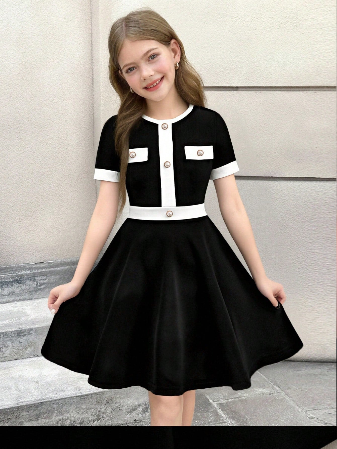 Nova Glow tween girls black and white houndstooth print short sleeve A-line dress with decorative buttons and crew neckline.