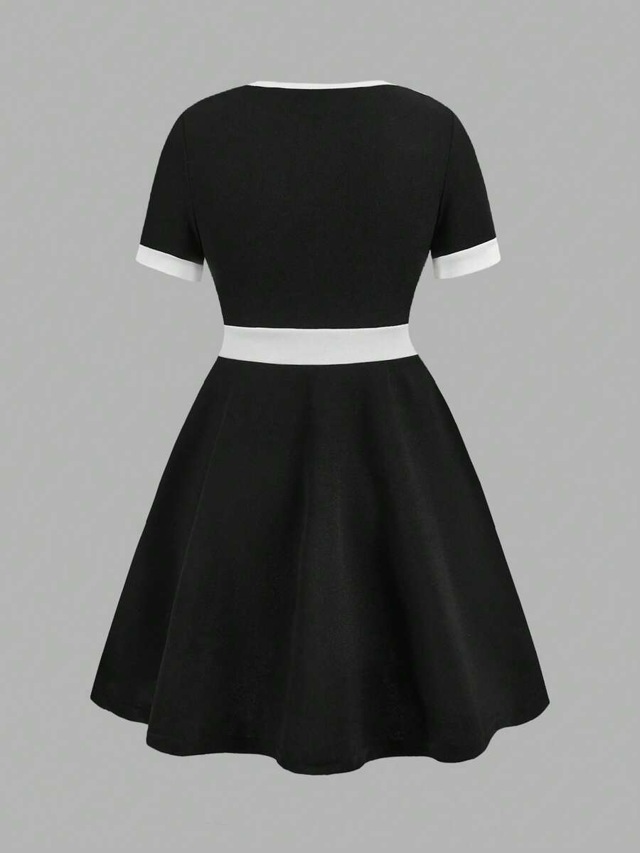 Nova Glow tween girls black and white houndstooth print short sleeve A-line dress with decorative buttons and crew neckline.