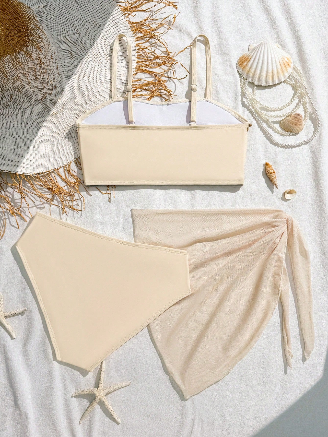 Tween girls bikini set with shell and starfish woven band details, spaghetti strap sleeveless top, and mid-waist skirt-style bottom in blue.