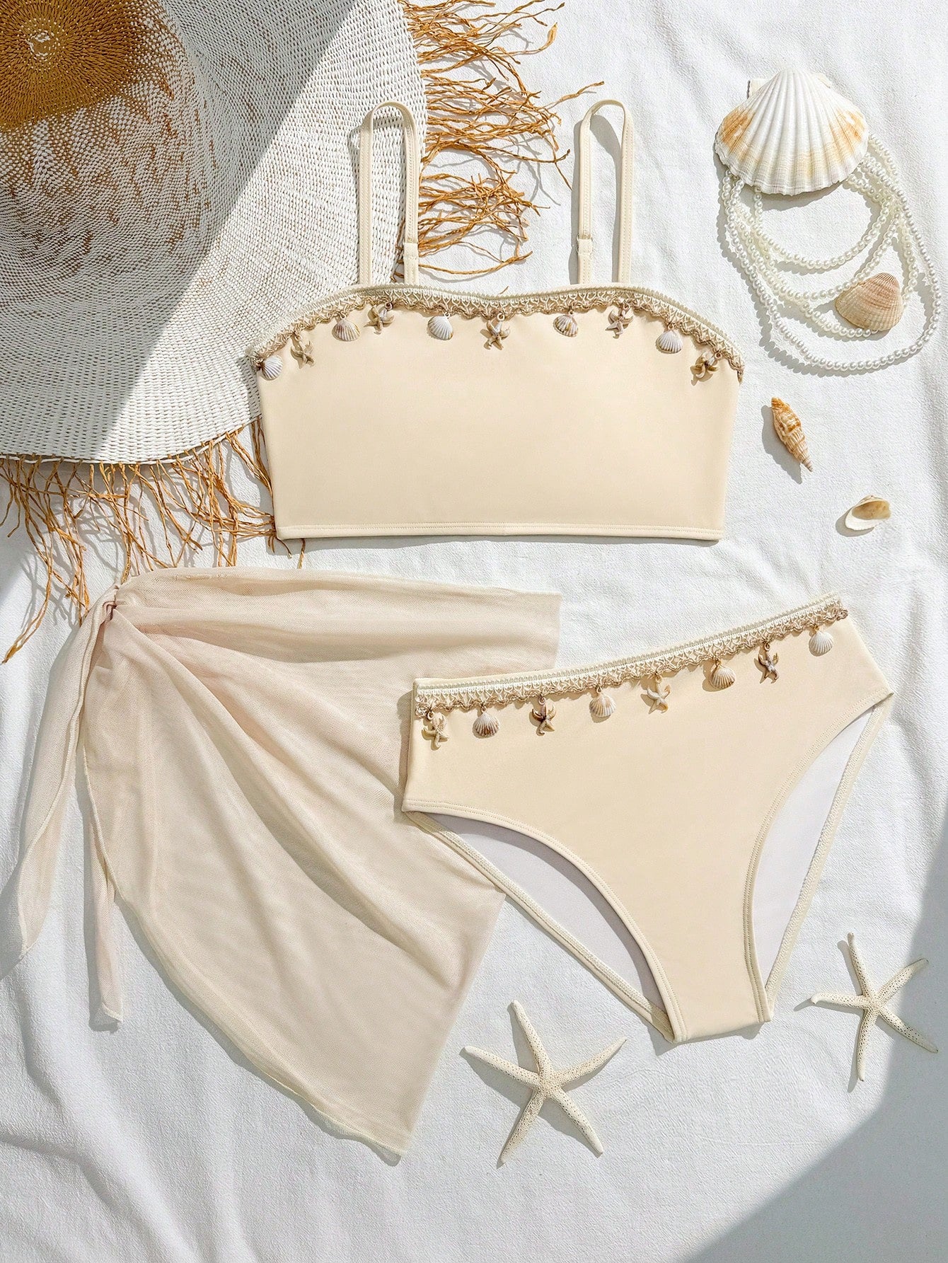 Tween girls bikini set with shell and starfish woven band details, spaghetti strap sleeveless top, and mid-waist skirt-style bottom in blue.