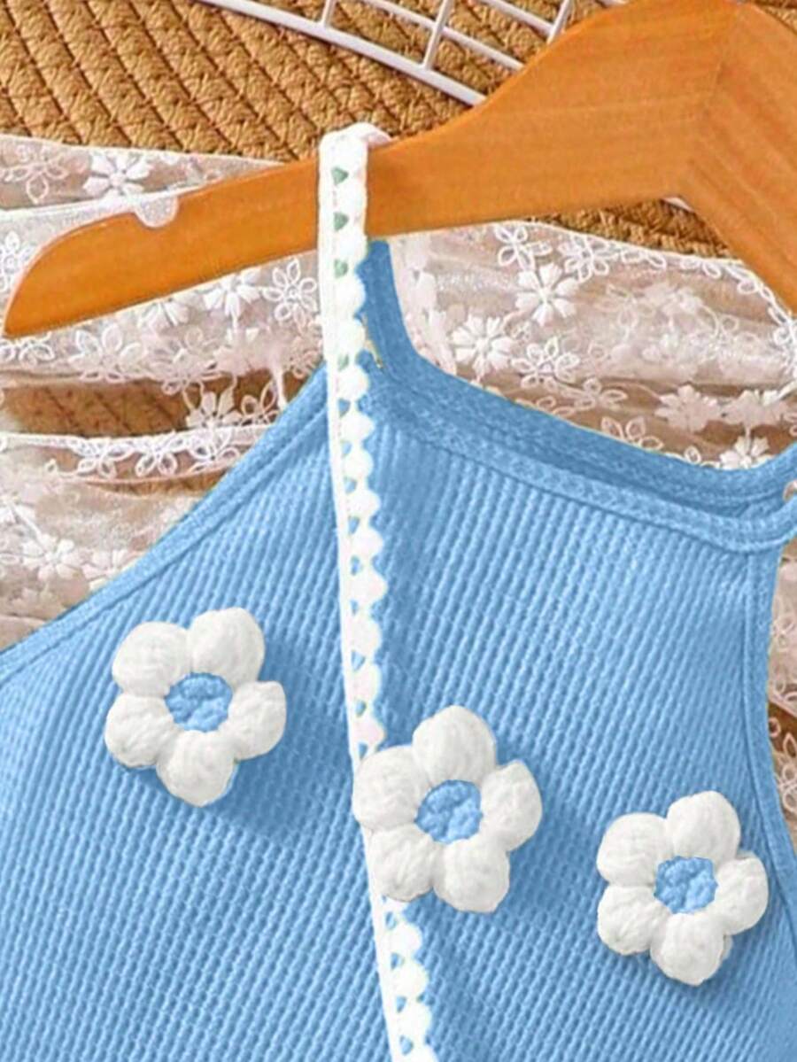 Girls' sleeveless summer midi dress with halter neckline, geometric pattern, applique and fringe details, shown with crossbody bag accessory with tassel decor