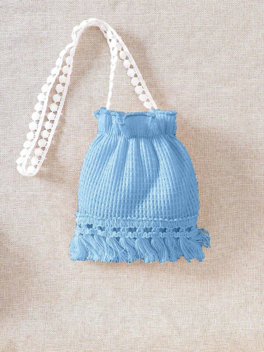 Girls' sleeveless summer midi dress with halter neckline, geometric pattern, applique and fringe details, shown with crossbody bag accessory with tassel decor