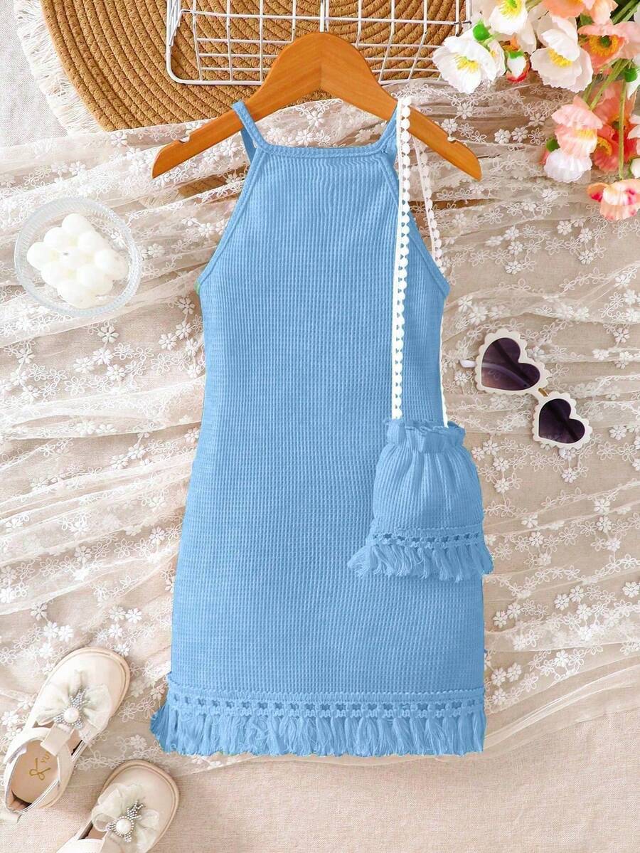 Girls' sleeveless summer midi dress with halter neckline, geometric pattern, applique and fringe details, shown with crossbody bag accessory with tassel decor