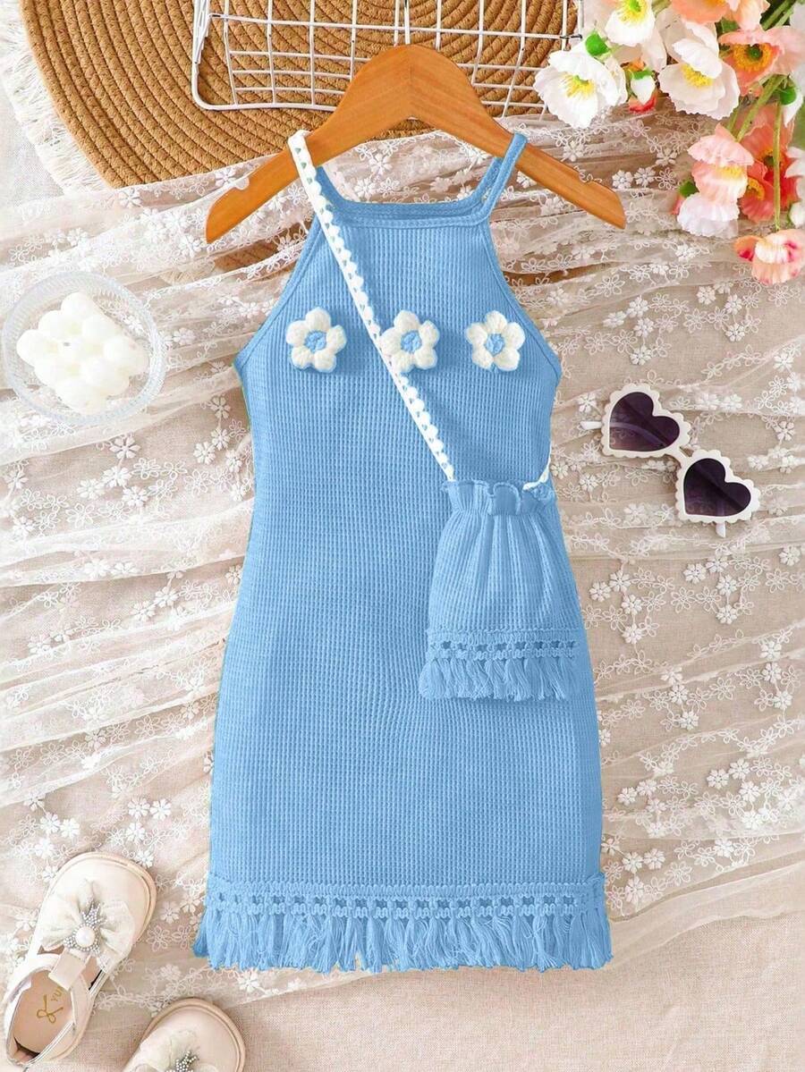 Girls' sleeveless summer midi dress with halter neckline, geometric pattern, applique and fringe details, shown with crossbody bag accessory with tassel decor