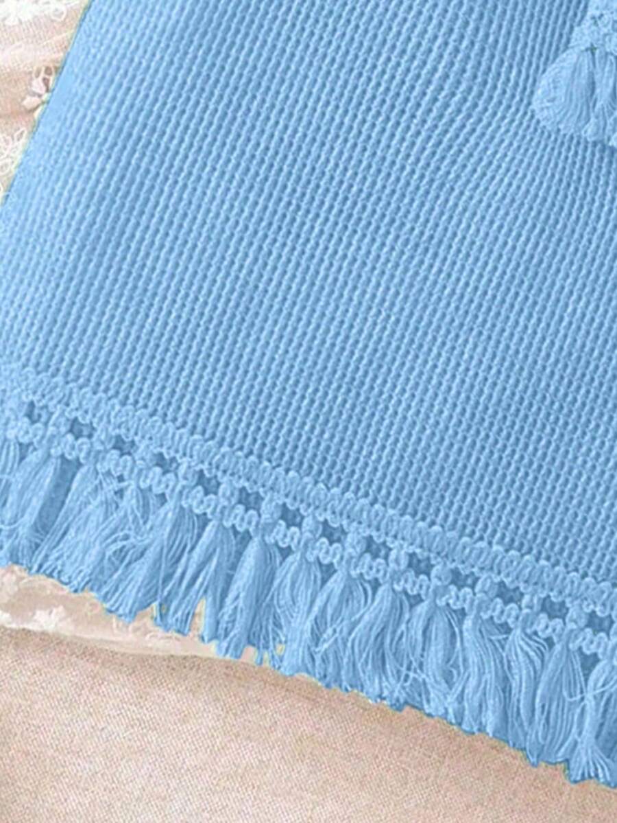Girls' sleeveless summer midi dress with halter neckline, geometric pattern, applique and fringe details, shown with crossbody bag accessory with tassel decor