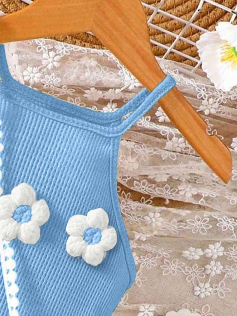 Girls' sleeveless summer midi dress with halter neckline, geometric pattern, applique and fringe details, shown with crossbody bag accessory with tassel decor