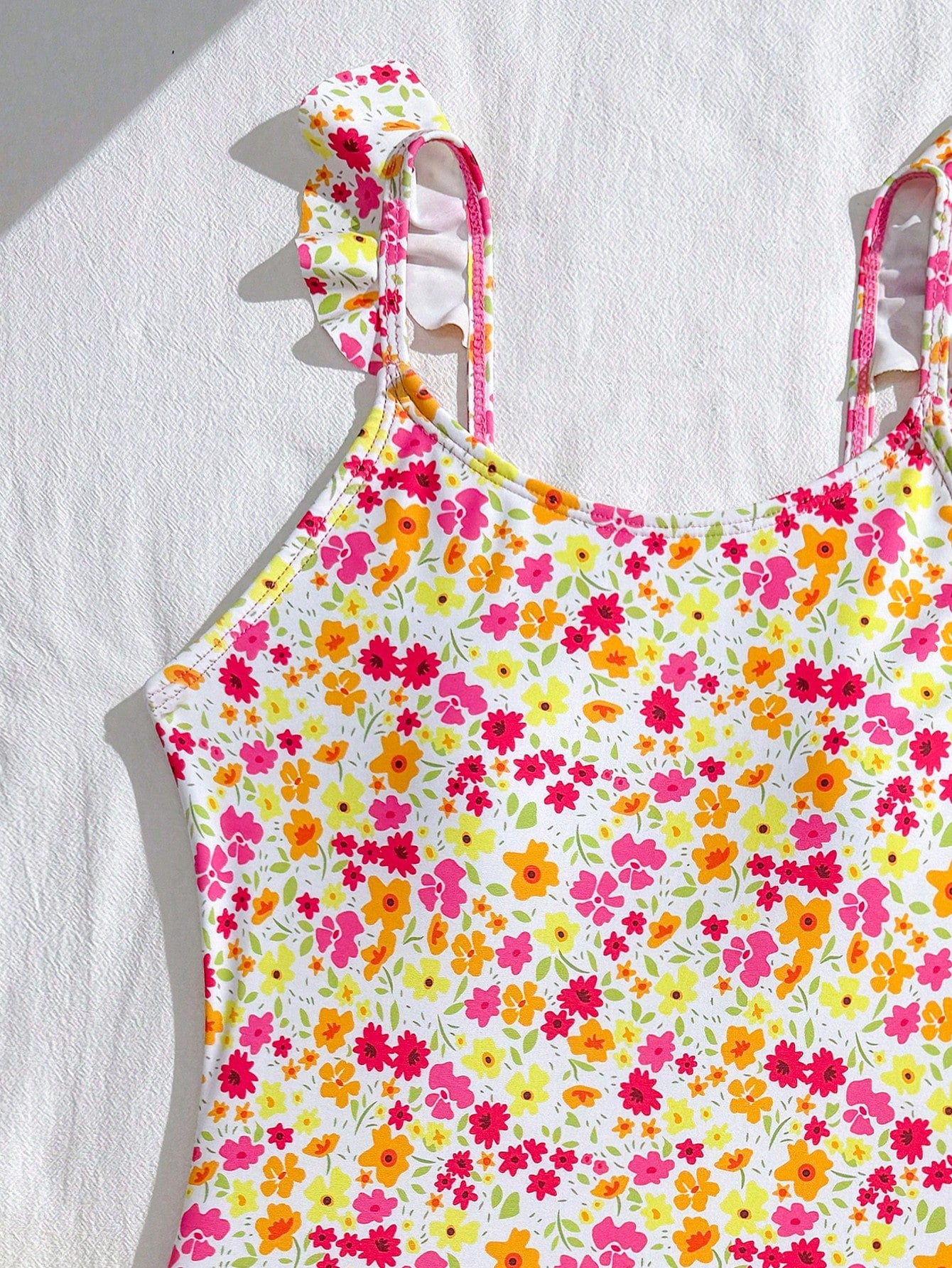 Tween girls one-piece swimsuit in leopard print with ruffle shoulder straps, scoop neckline, fitted shape, and attached ruffle hem skirt; sleeveless, mid-waist skirt bottom, and lined body for swimming, vacation, and summer beach wear.