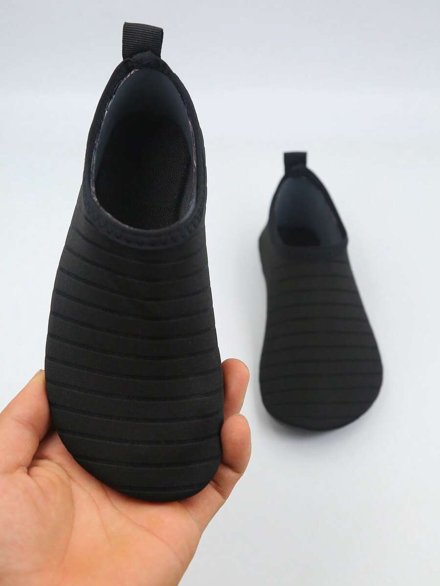 Kids slip-on aqua socks featuring geometric pattern, breathable Lycra upper, and non-slip TPR outsole for beach and water activities.