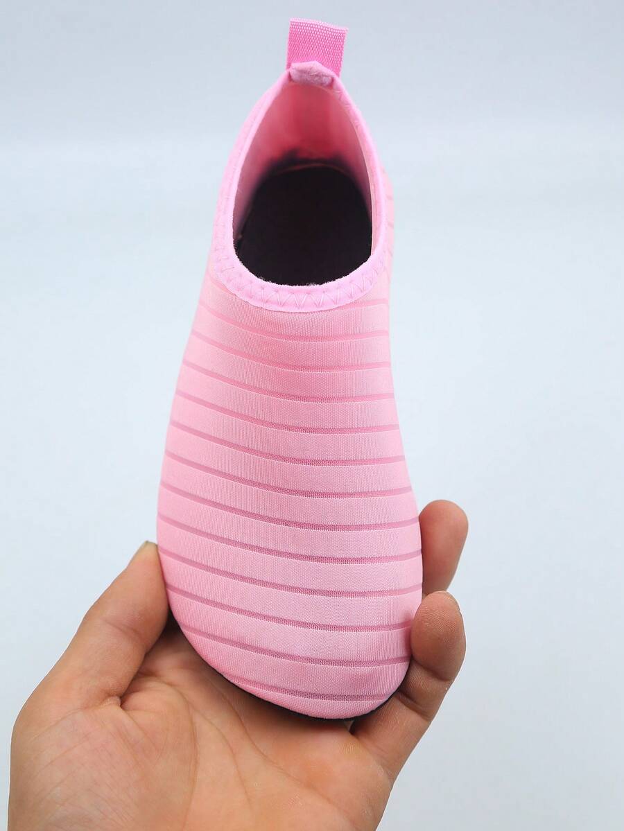 Kids slip-on aqua socks featuring geometric pattern, breathable Lycra upper, and non-slip TPR outsole for beach and water activities.
