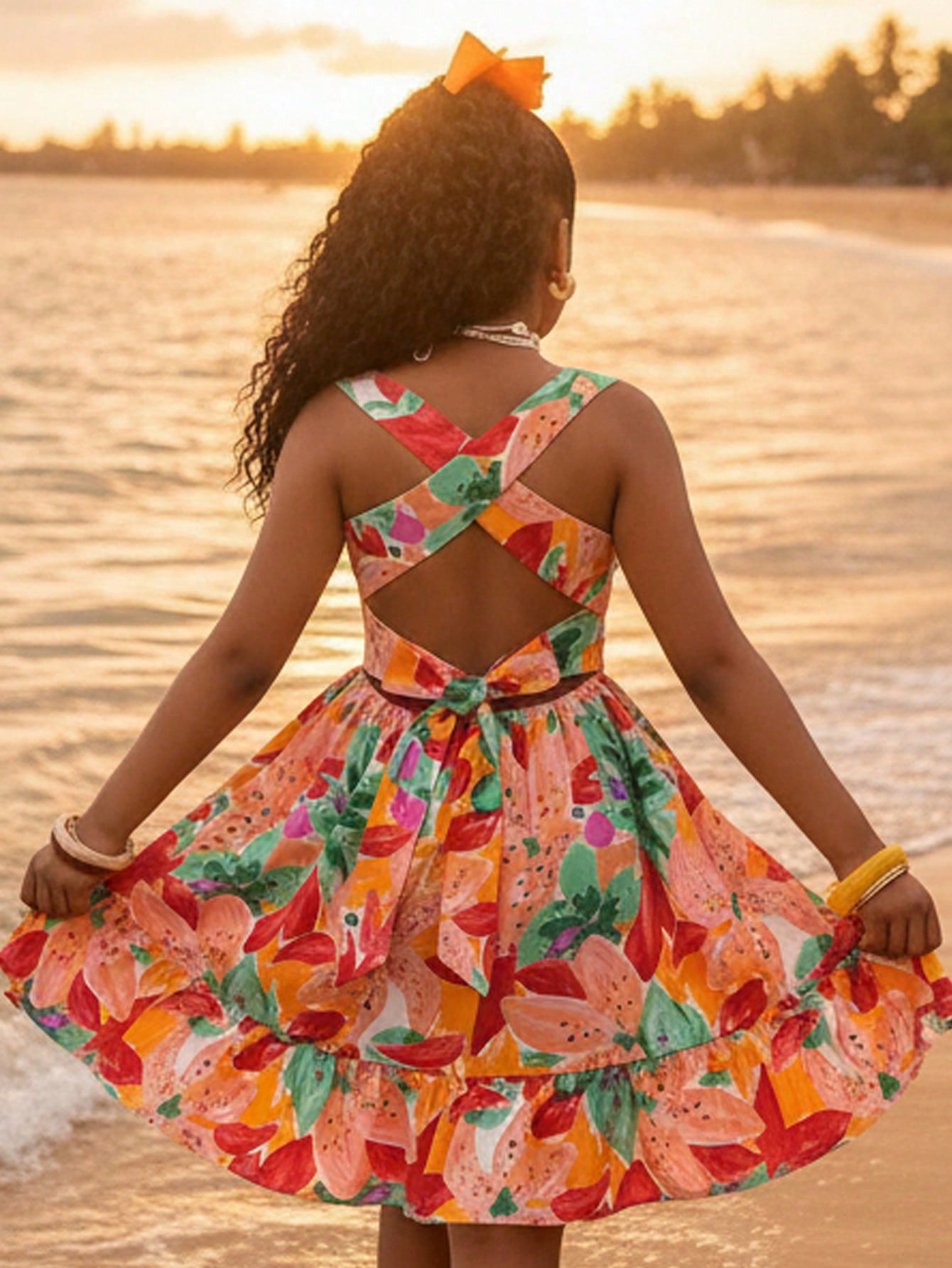 Tween girls multicolor tropical fruit and vegetable print short cami dress with spaghetti straps, bowknot belt detail, high waist, cut-out styling, and flared hem.
