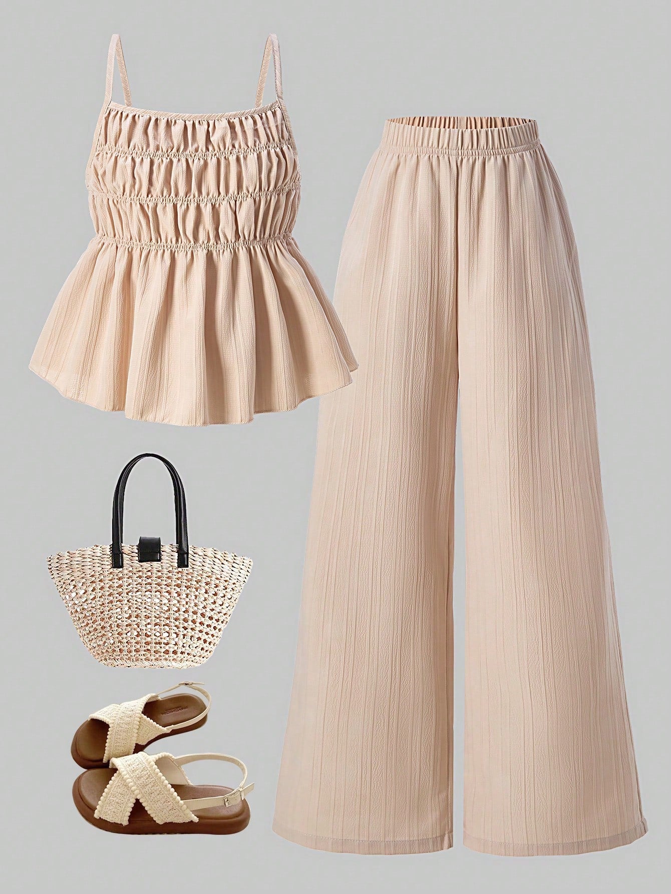 Tween girl wearing an apricot 2-piece outfit set featuring a shirred spaghetti strap short cami top and matching wide-leg long pants.