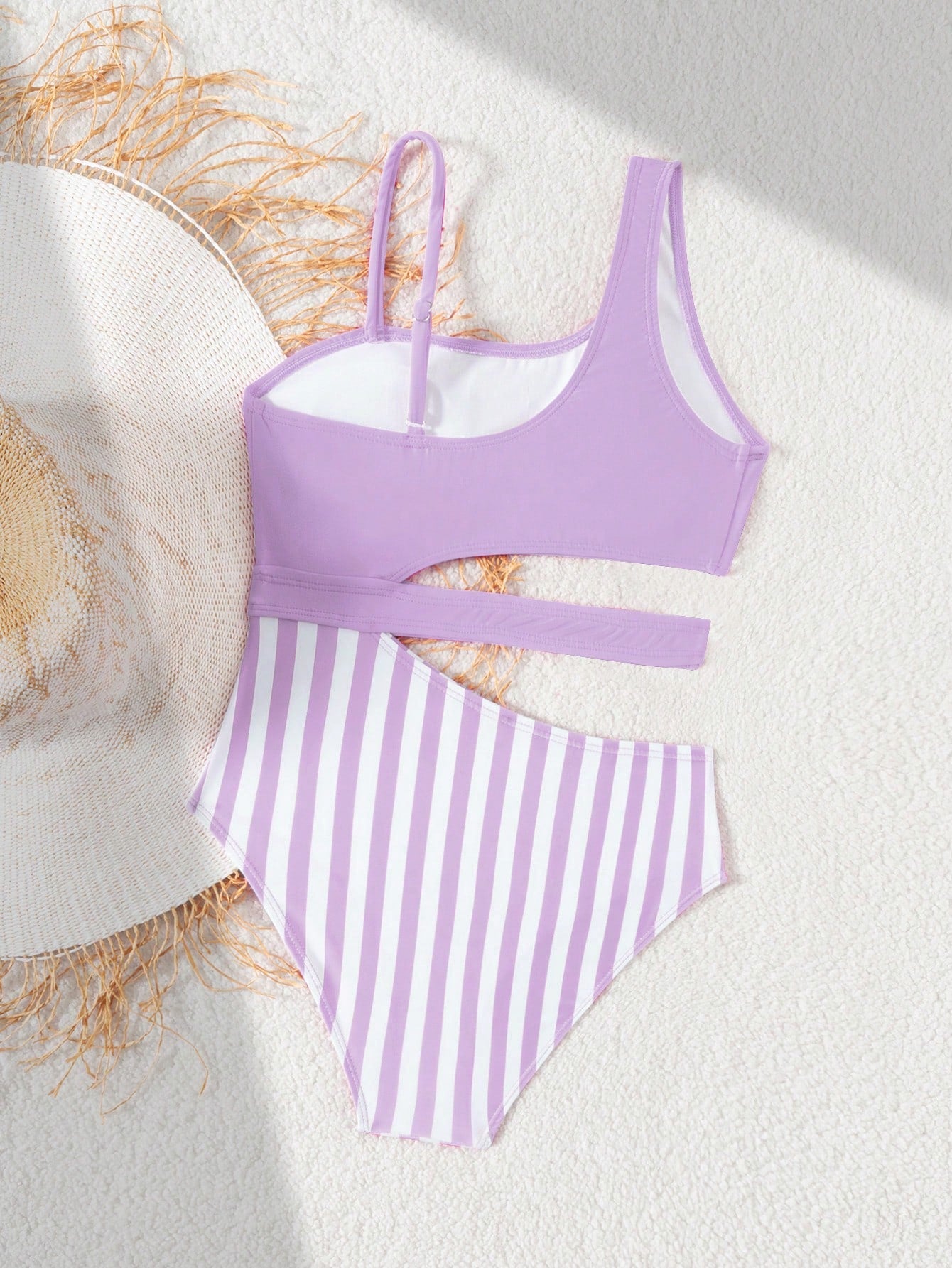 Purple tween girls one-piece swimsuit with asymmetrical neckline, cut-out waist, striped pattern, fitted silhouette, and lined body.