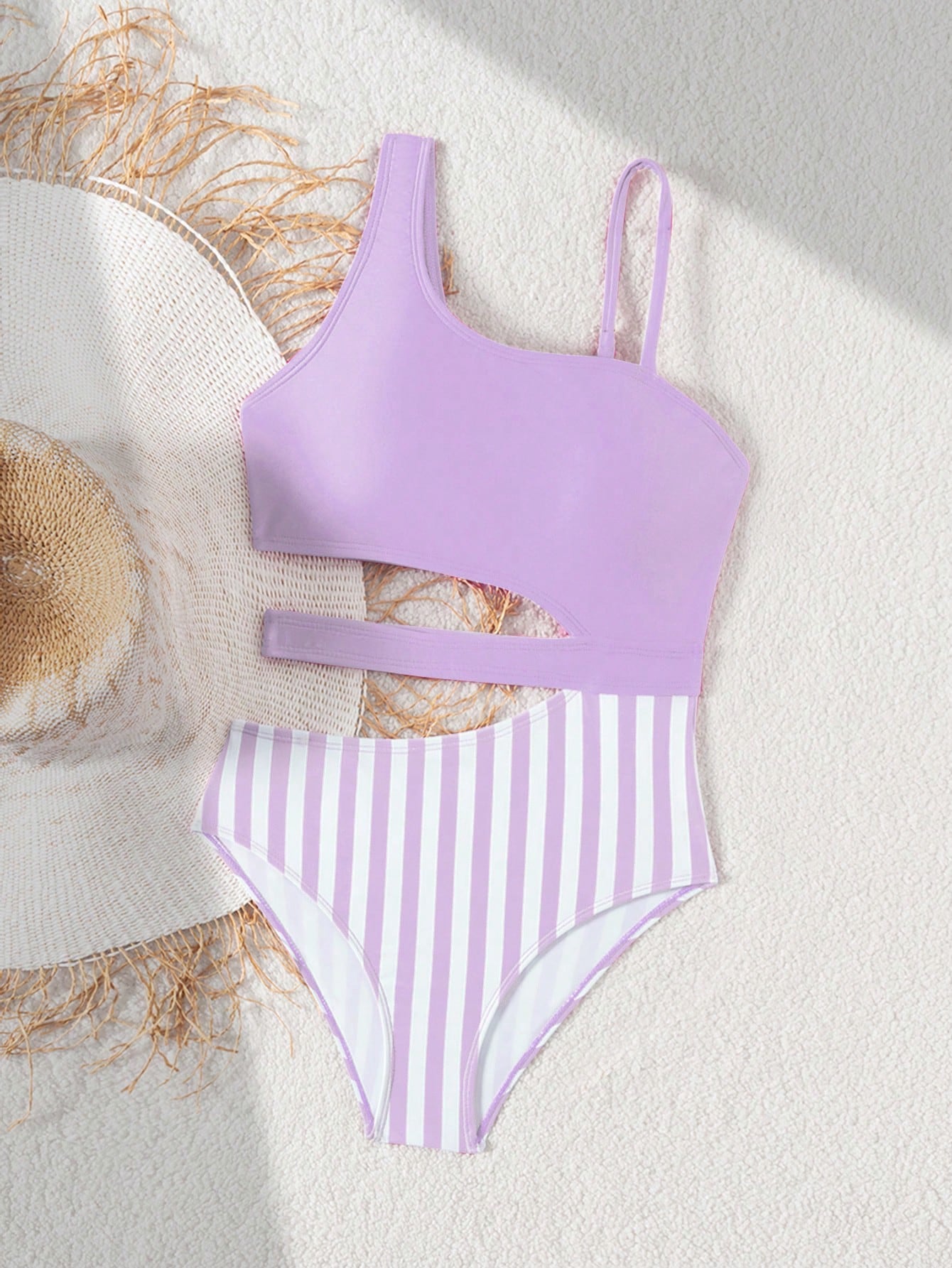 Purple tween girls one-piece swimsuit with asymmetrical neckline, cut-out waist, striped pattern, fitted silhouette, and lined body.