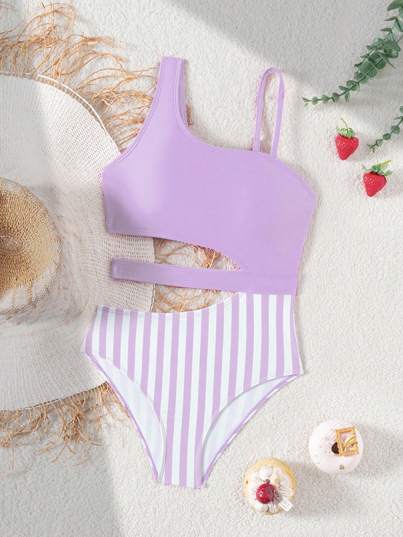 Purple tween girls one-piece swimsuit with asymmetrical neckline, cut-out waist, striped pattern, fitted silhouette, and lined body.