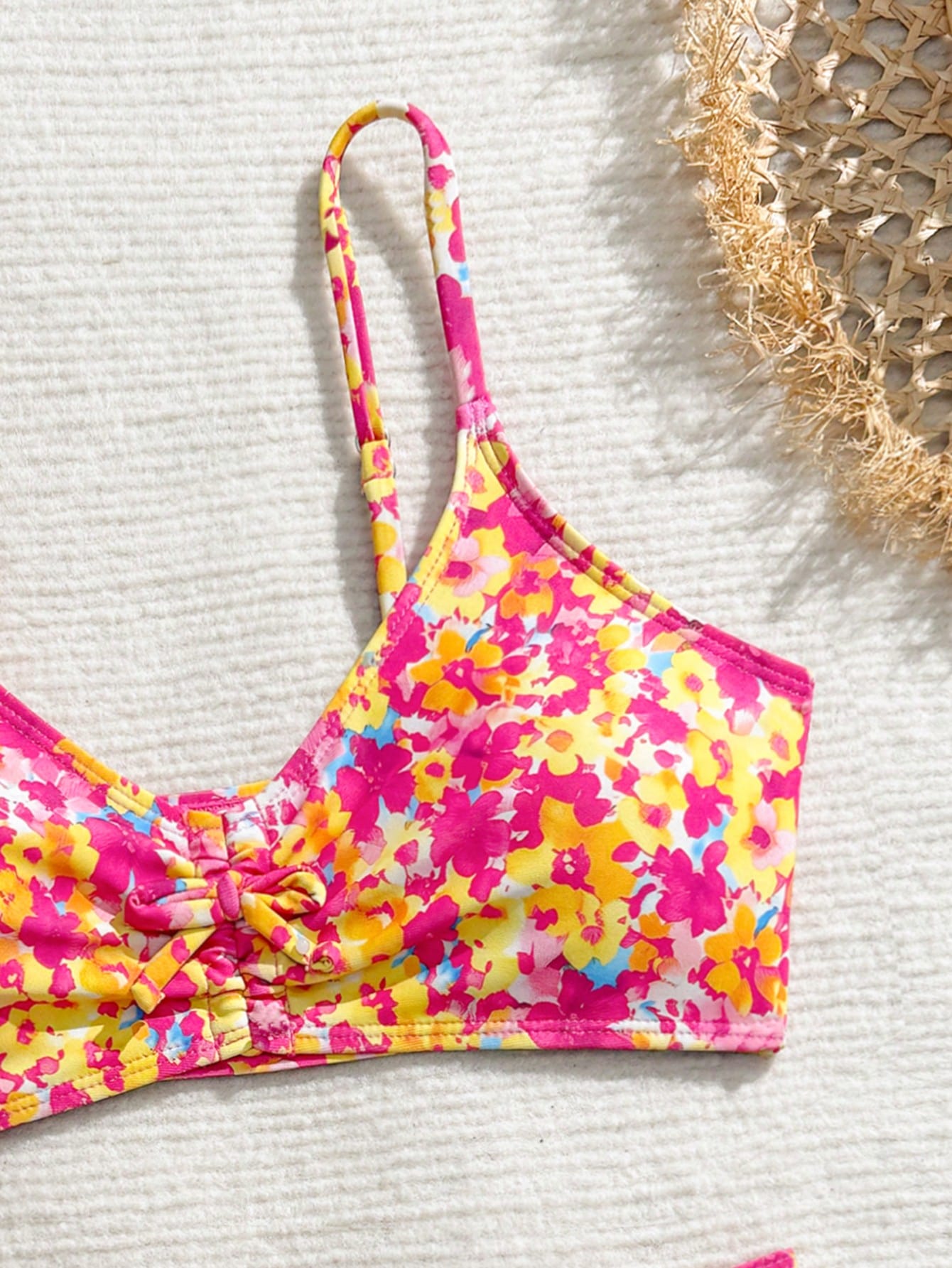 Tween girls 2-piece ditsy floral bikini set featuring a spaghetti strap top with center string detail and matching bottoms with side strings, designed for swimming, vacation, and summer wear.