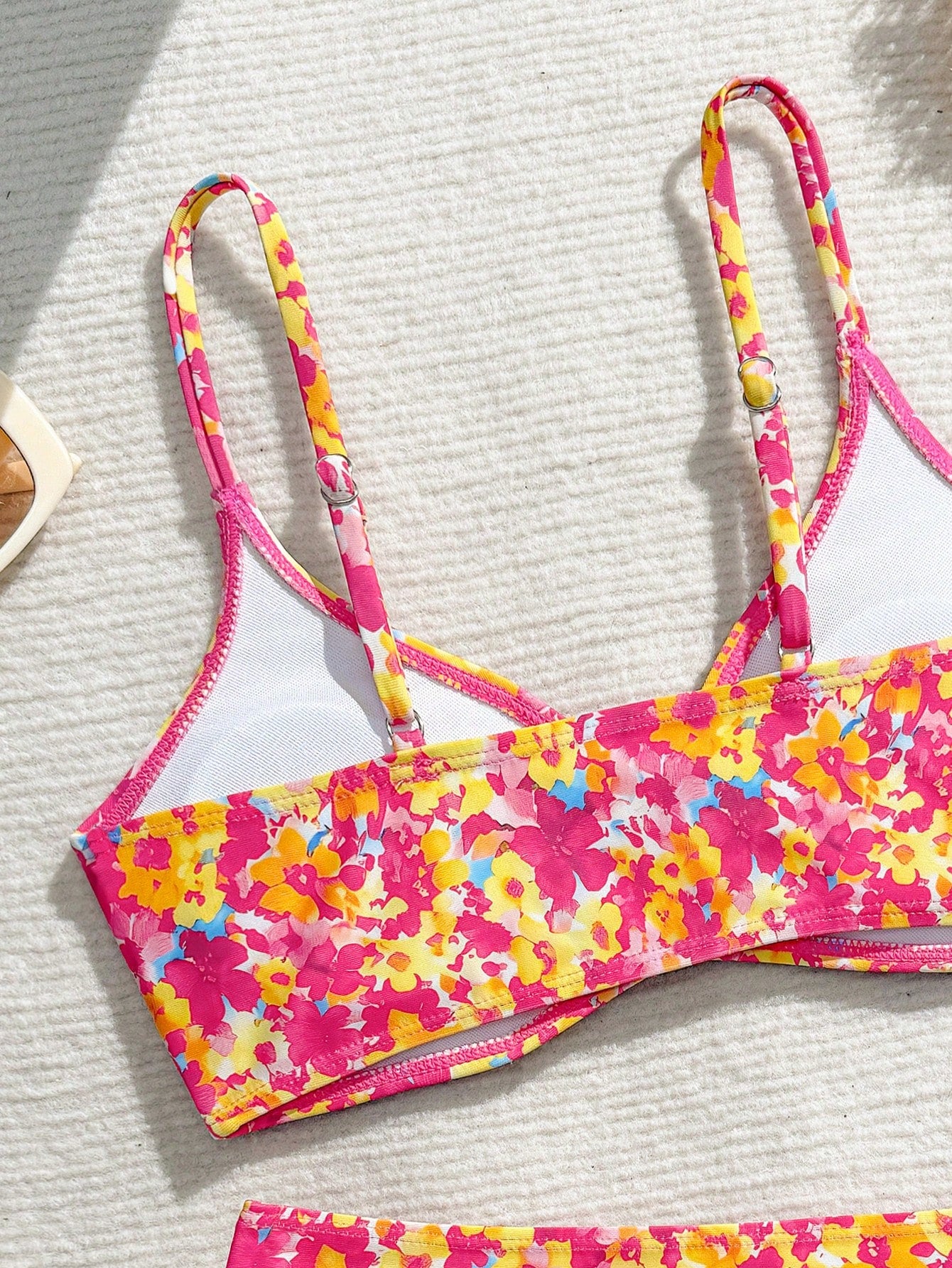 Tween girls 2-piece ditsy floral bikini set featuring a spaghetti strap top with center string detail and matching bottoms with side strings, designed for swimming, vacation, and summer wear.