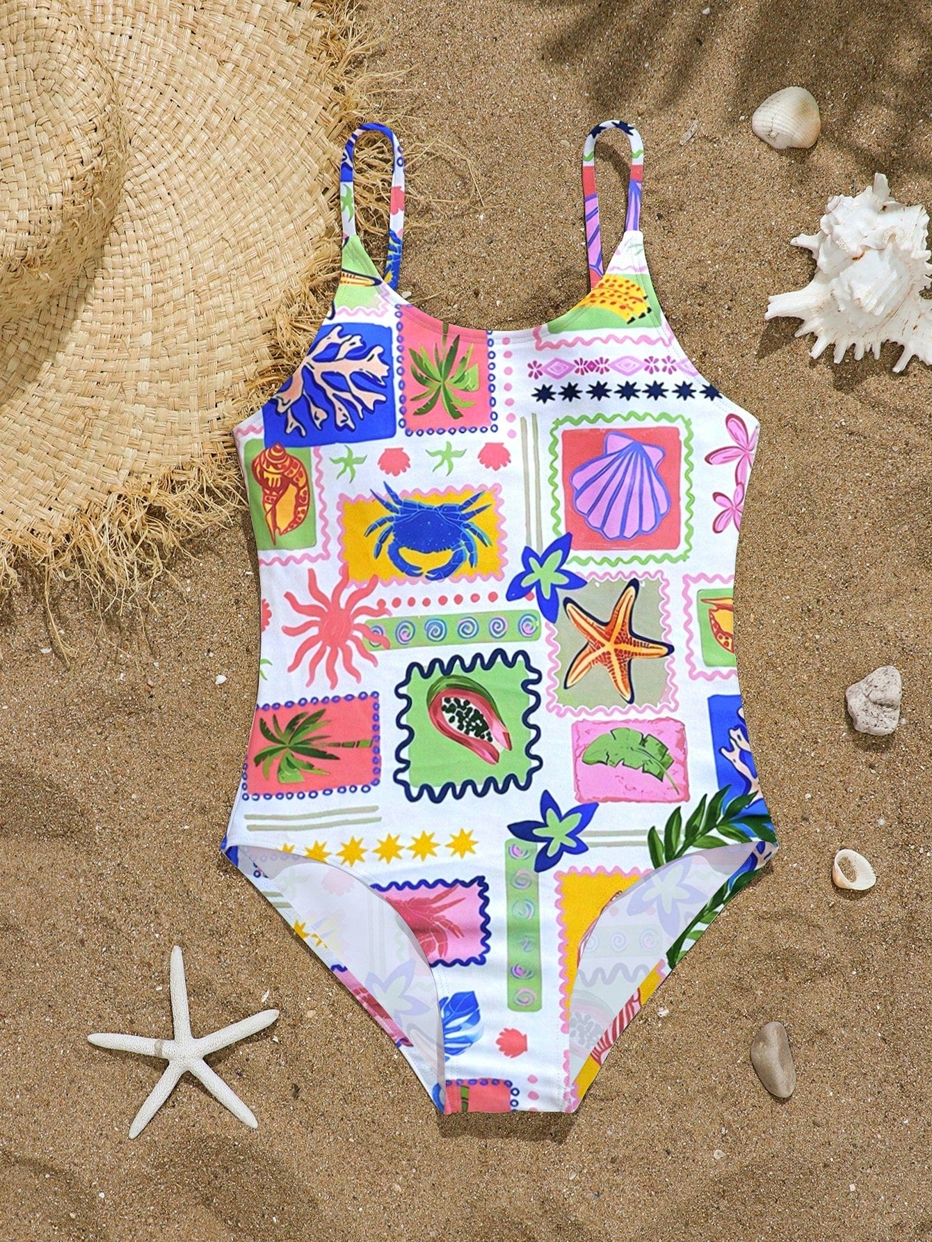 Tween girls one-piece swimsuit with multicolor ocean shell and seahorse all-over print, spaghetti straps, cut-out detail, and lined body for beach or swimming.