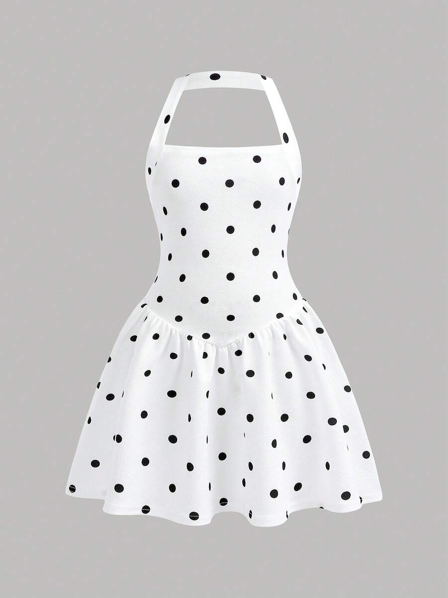Black sleeveless halter polka dot mini dress for tween girls featuring a high waist and flared hem