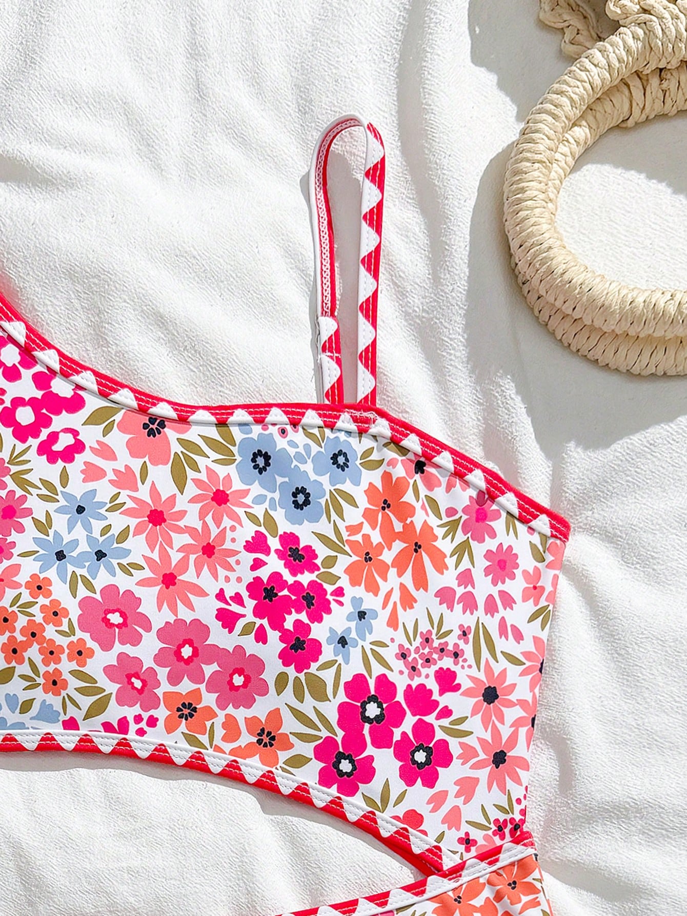 Tween girls one-piece swimsuit featuring an asymmetric neckline, pendant decor, plain design, wireless bra, high-cut bottom, and medium-stretch fabric.