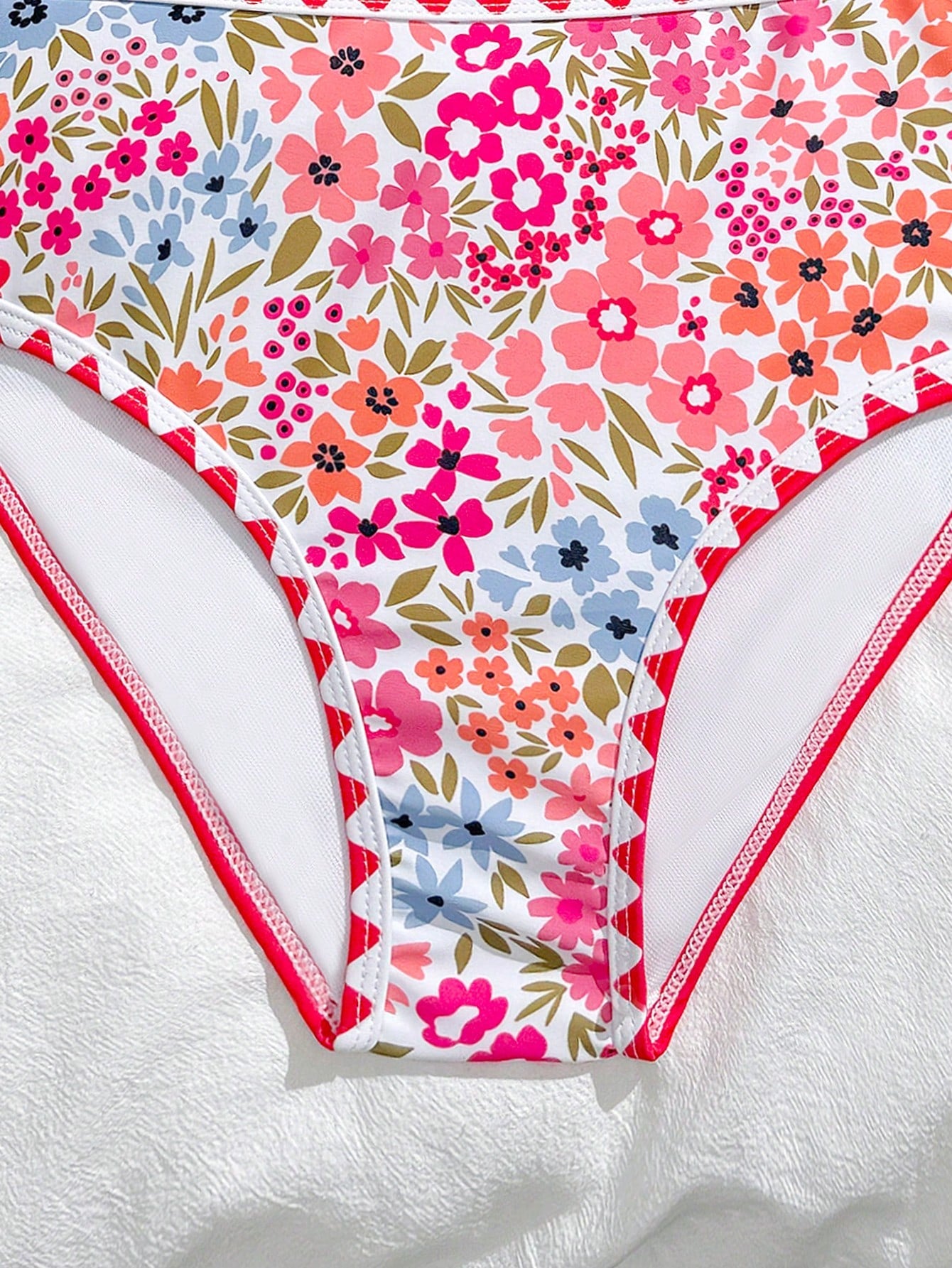 Tween girls one-piece swimsuit featuring an asymmetric neckline, pendant decor, plain design, wireless bra, high-cut bottom, and medium-stretch fabric.
