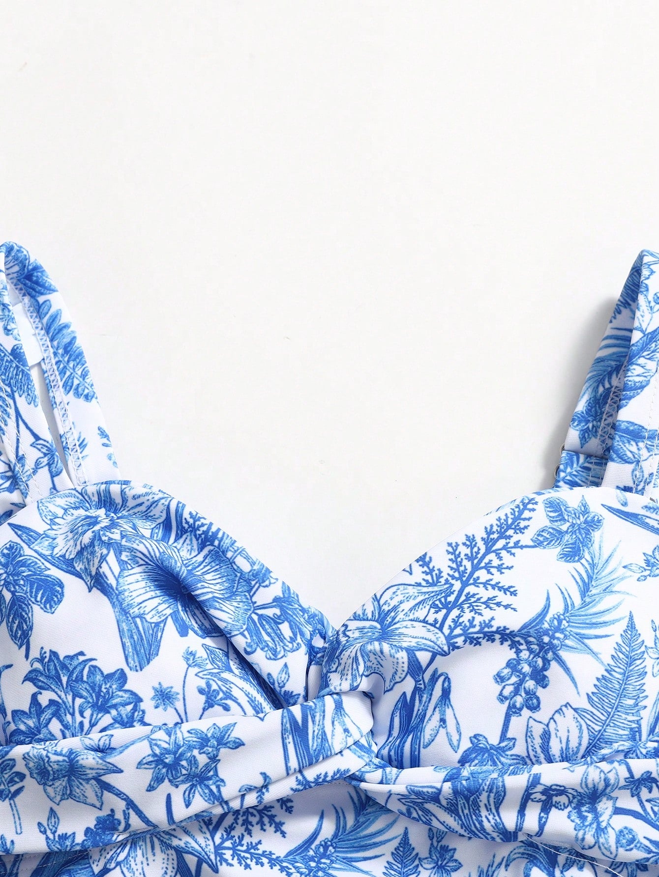 Tween girls blue and white floral print one-piece swimsuit with ruffle detail, spaghetti straps, V-neck styling, and vacation beachwear look.