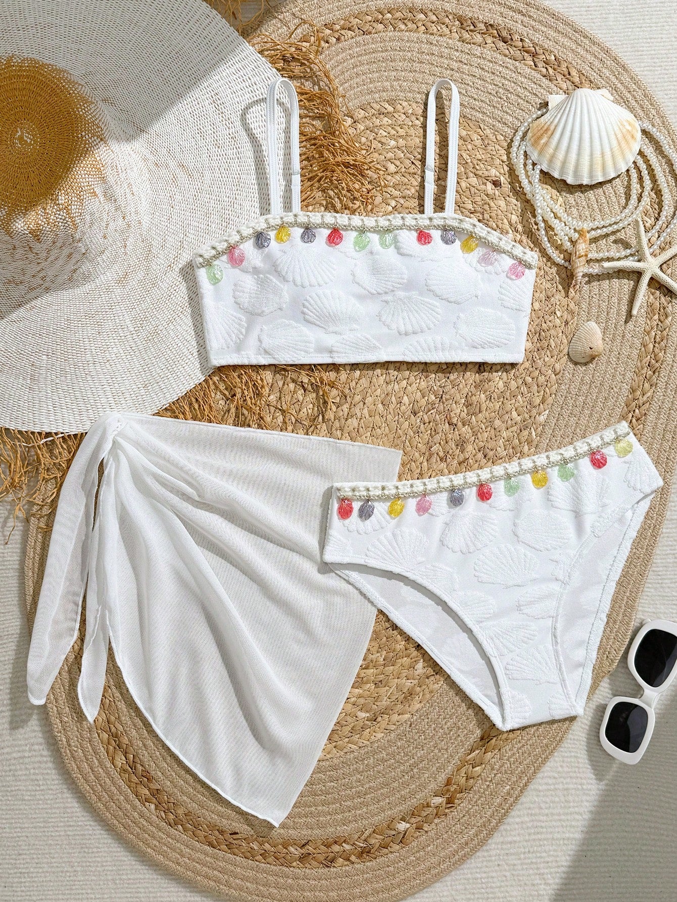 Tween girls bikini set with shell and starfish woven band details, spaghetti strap sleeveless top, and mid-waist skirt-style bottom in blue.