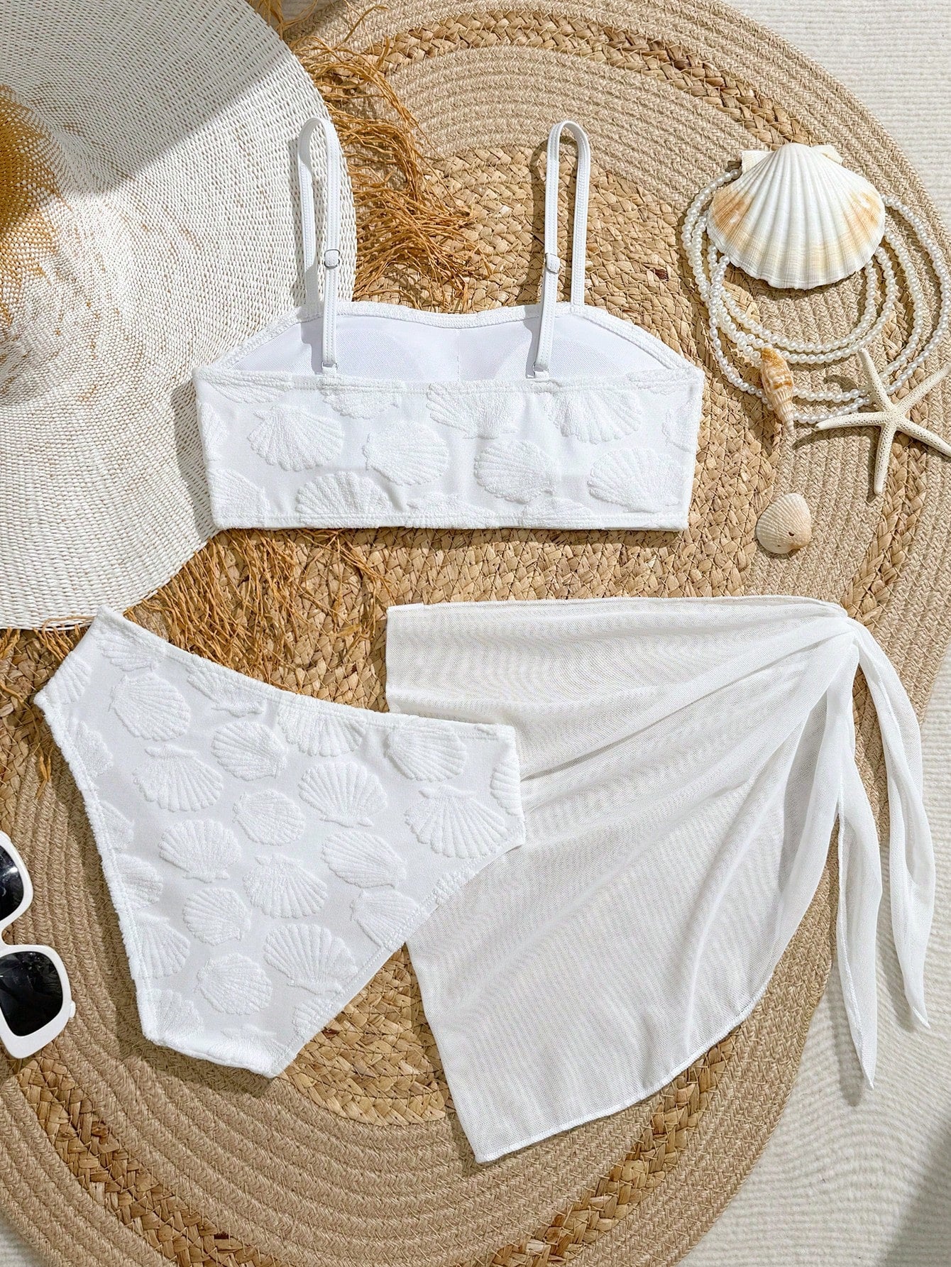 Tween girls bikini set with shell and starfish woven band details, spaghetti strap sleeveless top, and mid-waist skirt-style bottom in blue.