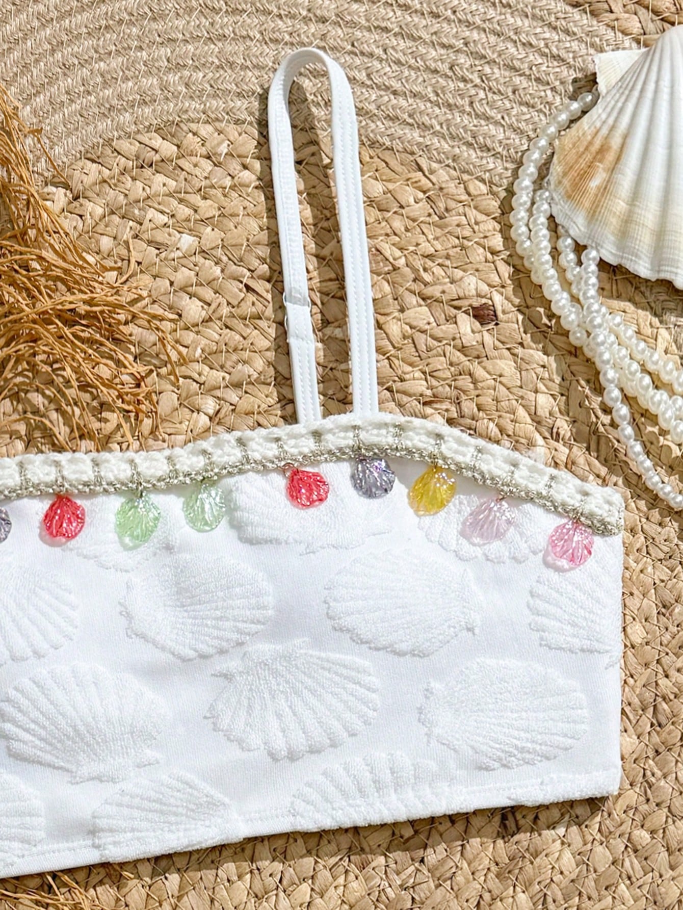 Tween girls bikini set with shell and starfish woven band details, spaghetti strap sleeveless top, and mid-waist skirt-style bottom in blue.