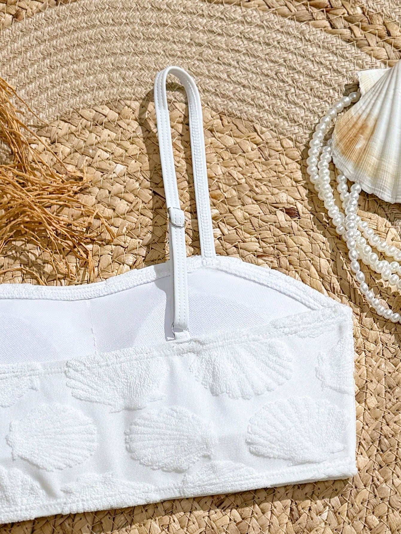 Tween girls bikini set with shell and starfish woven band details, spaghetti strap sleeveless top, and mid-waist skirt-style bottom in blue.