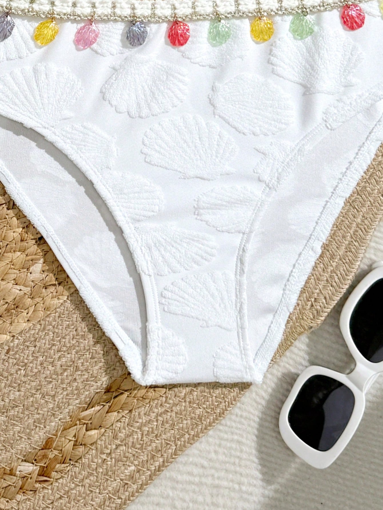 Tween girls bikini set with shell and starfish woven band details, spaghetti strap sleeveless top, and mid-waist skirt-style bottom in blue.