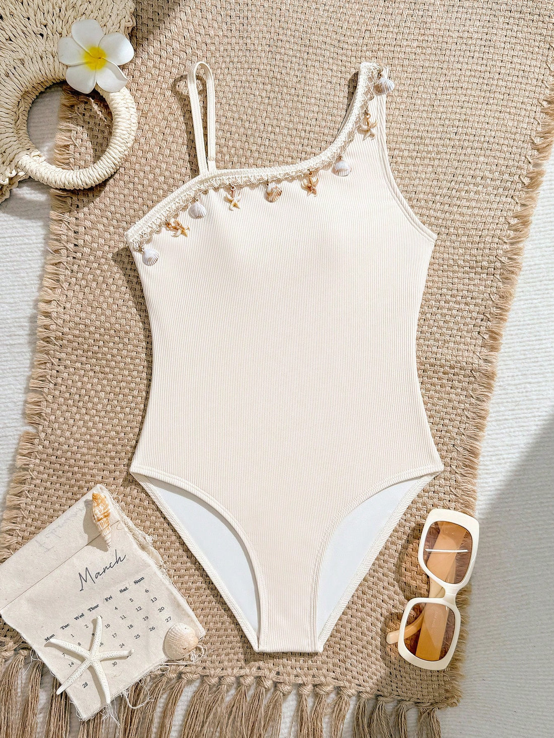 Tween girls one-piece swimsuit featuring an asymmetric neckline, pendant decor, plain design, wireless bra, high-cut bottom, and medium-stretch fabric.