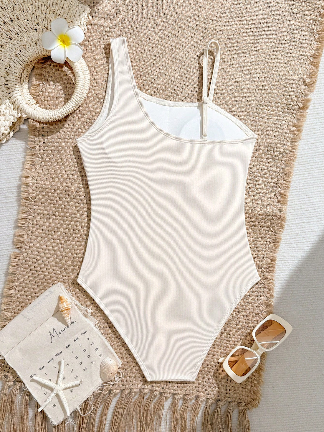 Tween girls one-piece swimsuit featuring an asymmetric neckline, pendant decor, plain design, wireless bra, high-cut bottom, and medium-stretch fabric.