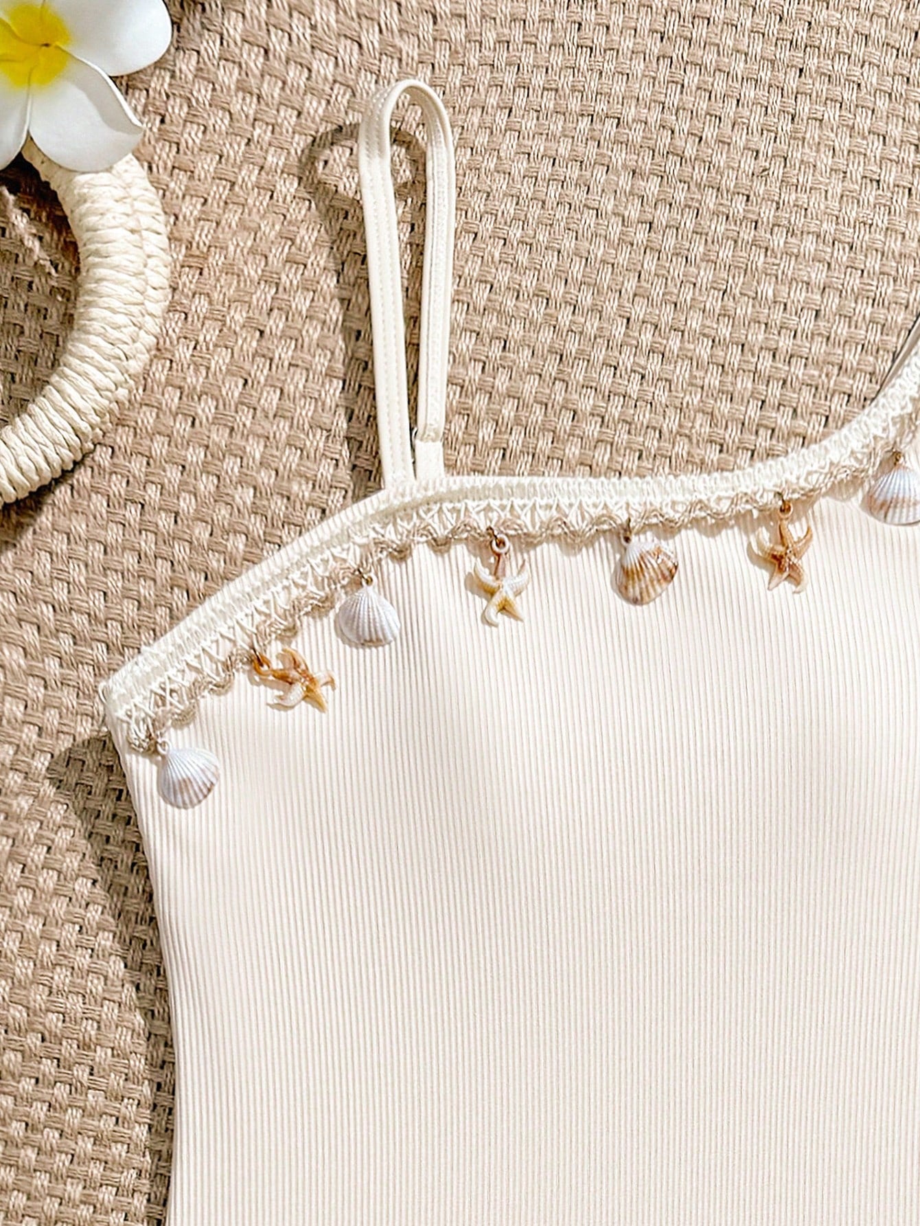 Tween girls one-piece swimsuit featuring an asymmetric neckline, pendant decor, plain design, wireless bra, high-cut bottom, and medium-stretch fabric.