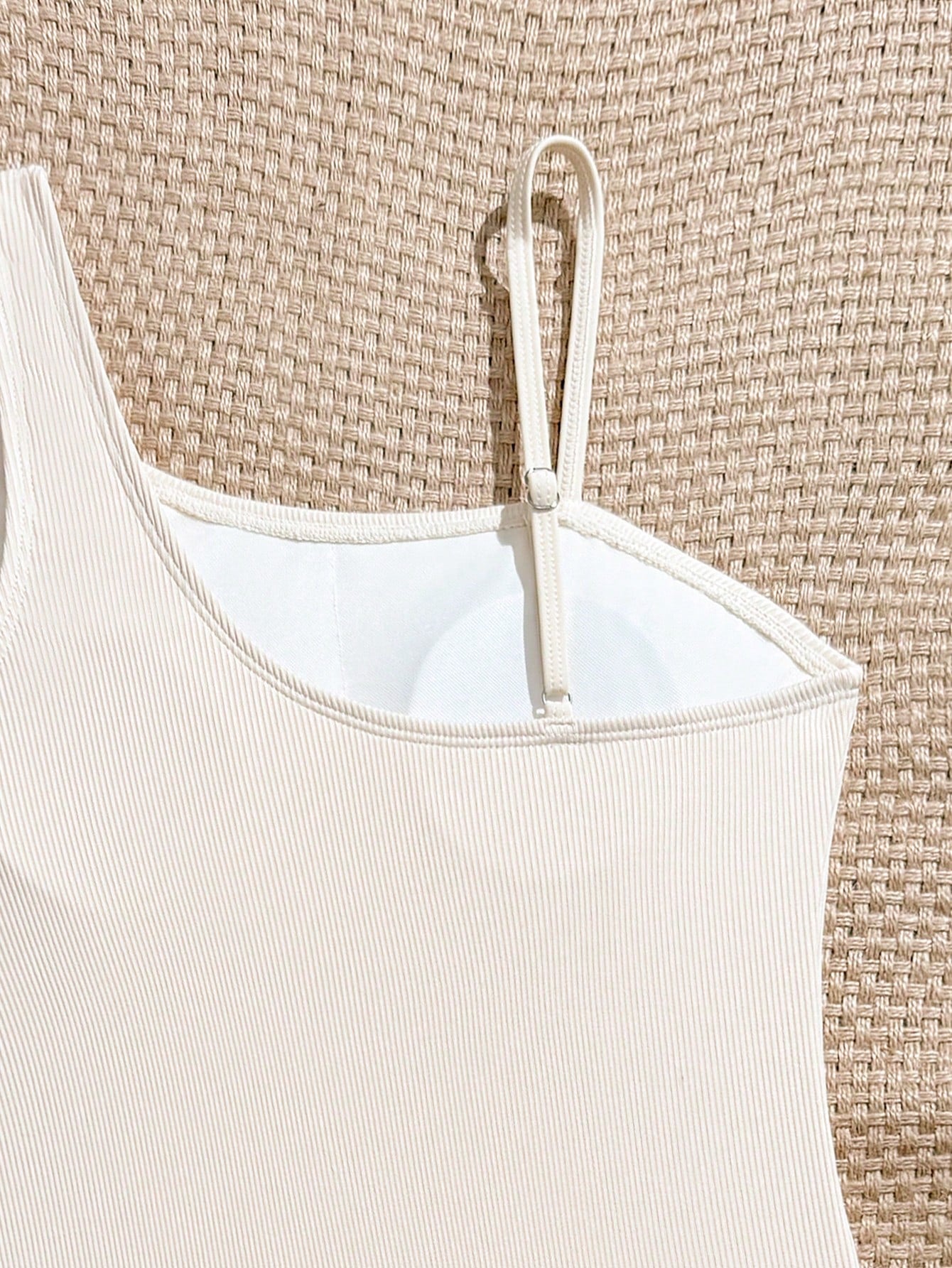 Tween girls one-piece swimsuit featuring an asymmetric neckline, pendant decor, plain design, wireless bra, high-cut bottom, and medium-stretch fabric.
