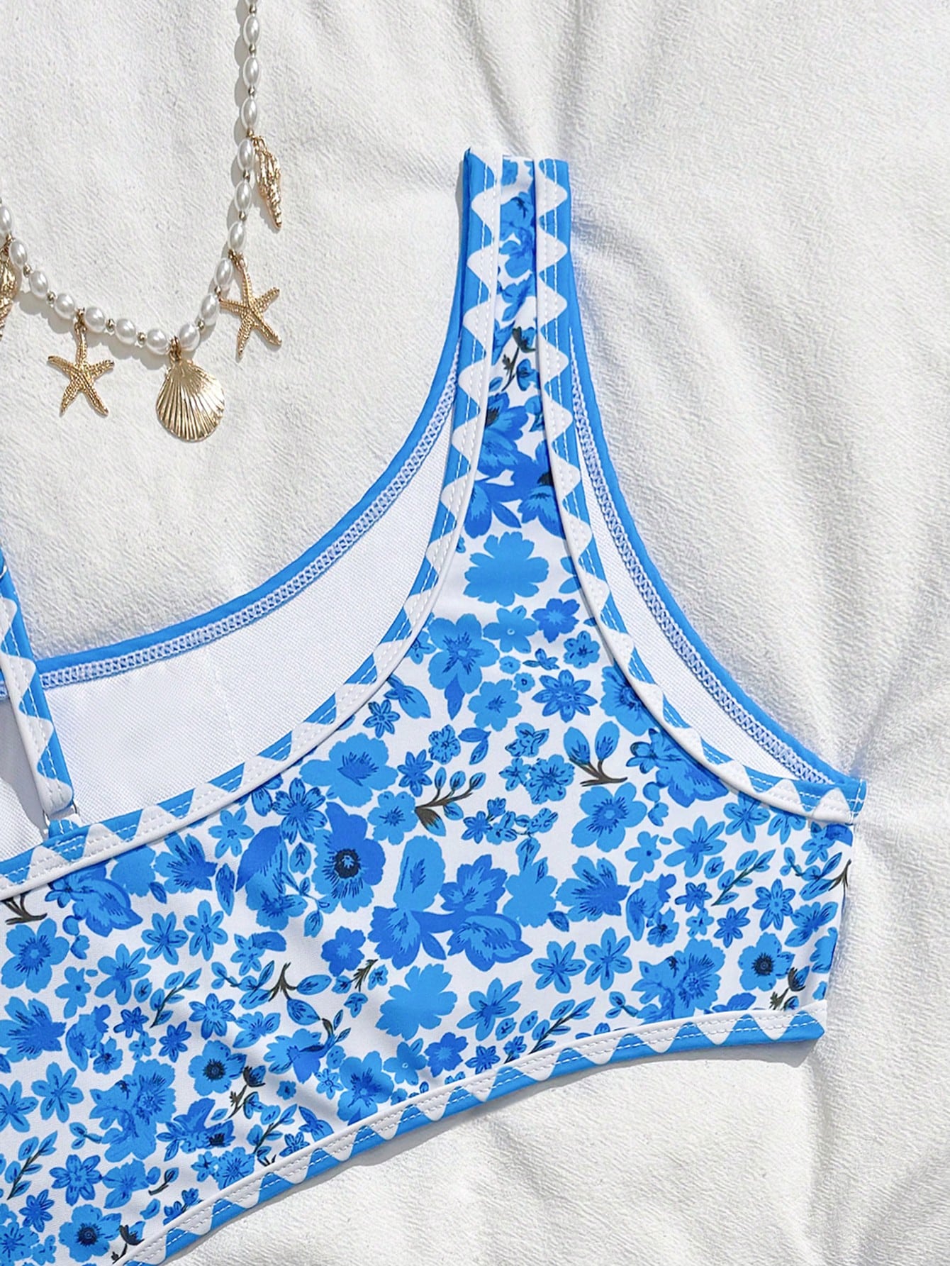 Tween girls one-piece swimsuit featuring an asymmetric neckline, pendant decor, plain design, wireless bra, high-cut bottom, and medium-stretch fabric.