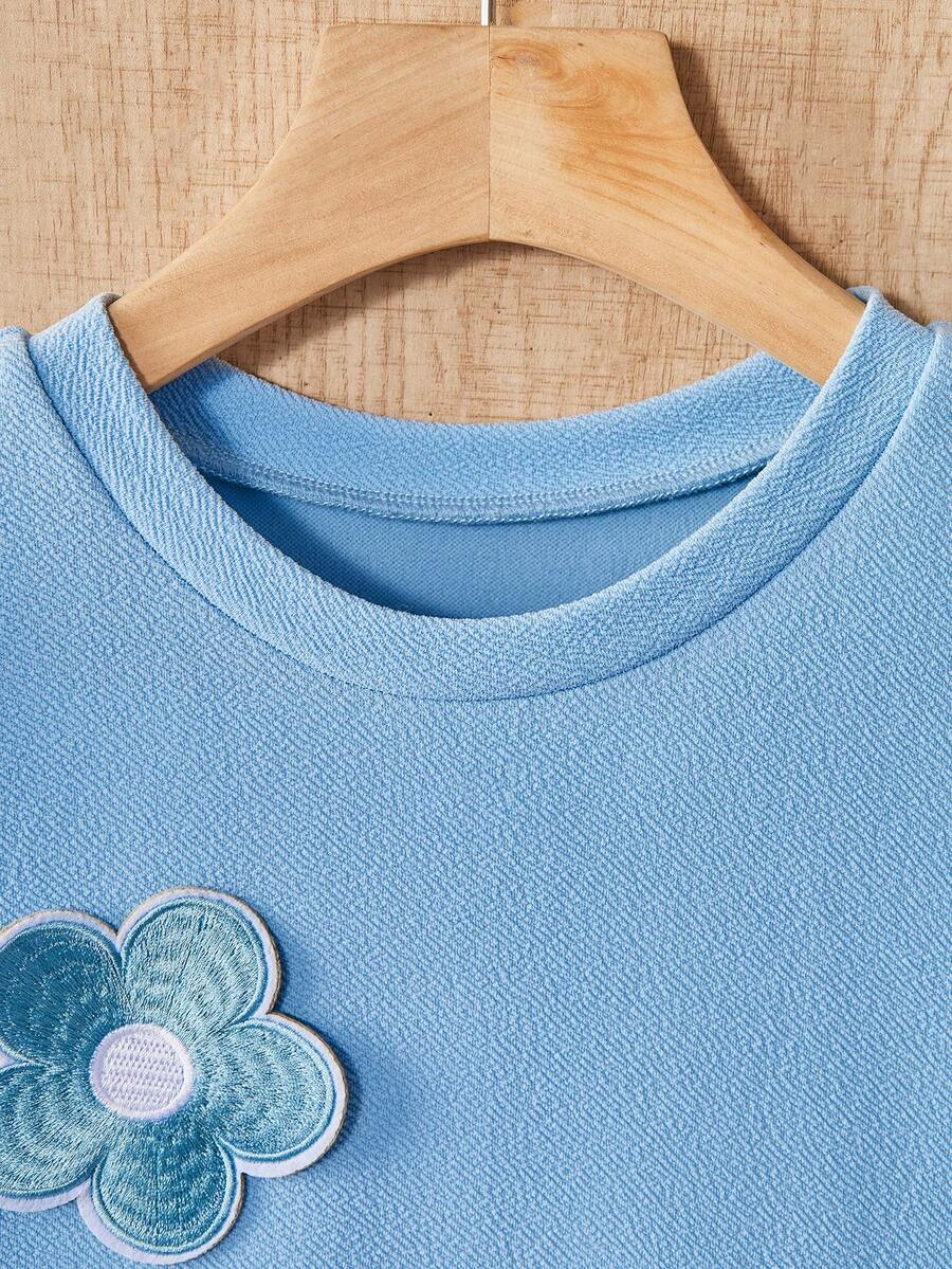 Tween girls apricot short-sleeve pleated smock dress with 3D bow decor and round neckline.