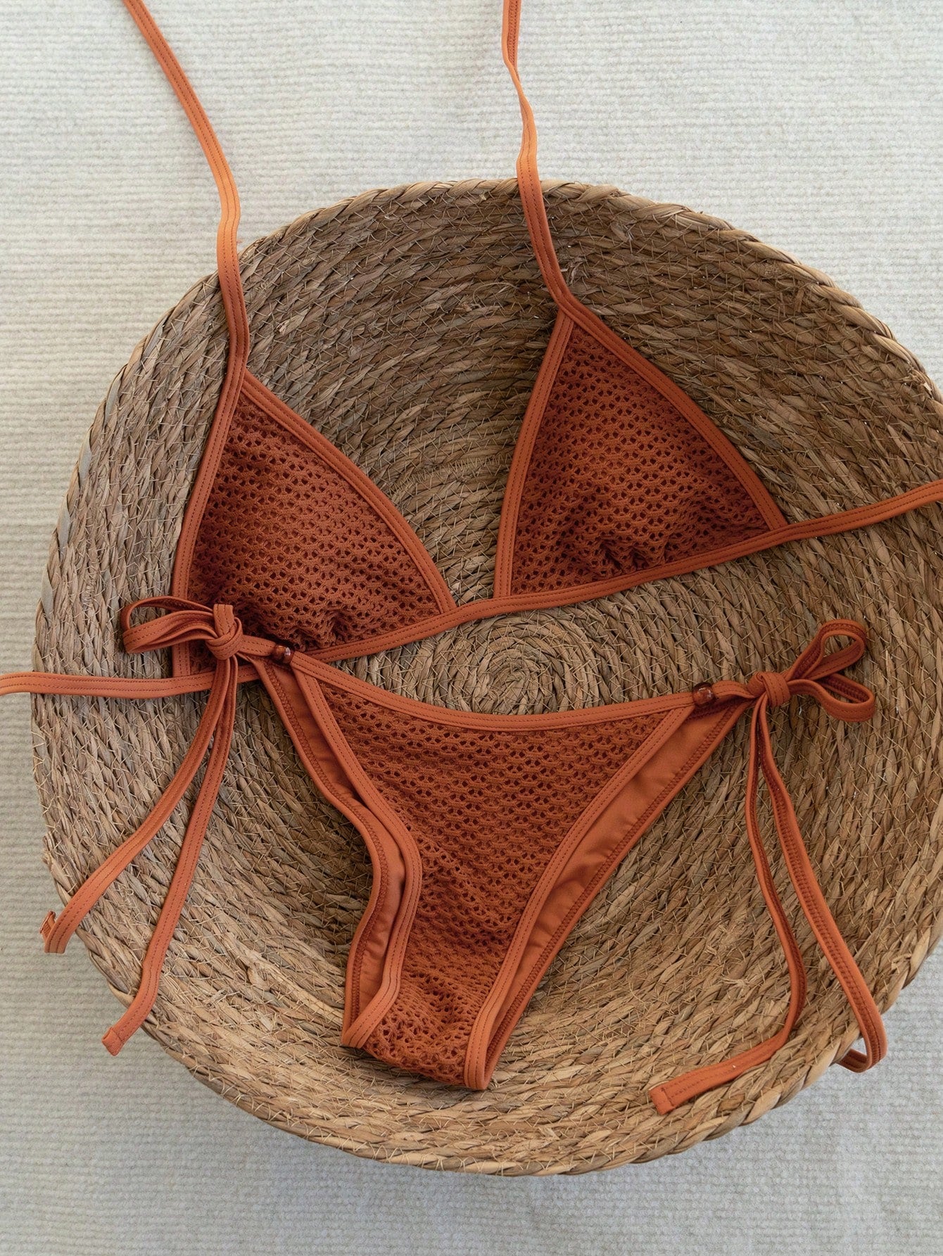 Women's apricot solid halter tie bikini top with triangle cups and matching tie-side swimsuit bottoms.
