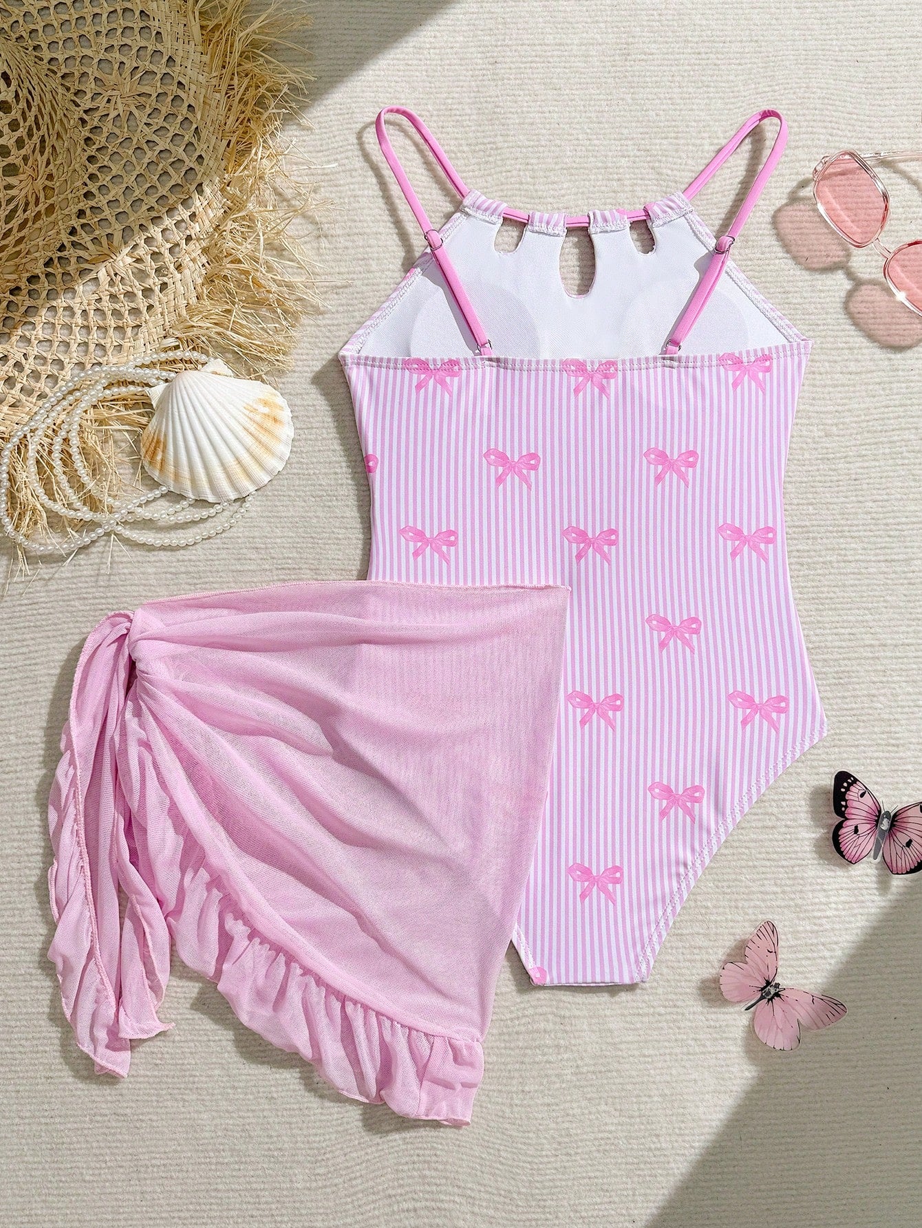 Girls black and white one-piece swimsuit set with cut-out detail, spaghetti straps, sleeveless fitted design, and matching skirt bottom for vacation swimwear.