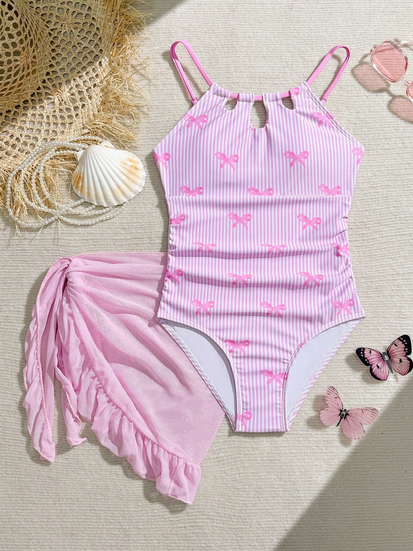 Girls black and white one-piece swimsuit set with cut-out detail, spaghetti straps, sleeveless fitted design, and matching skirt bottom for vacation swimwear.