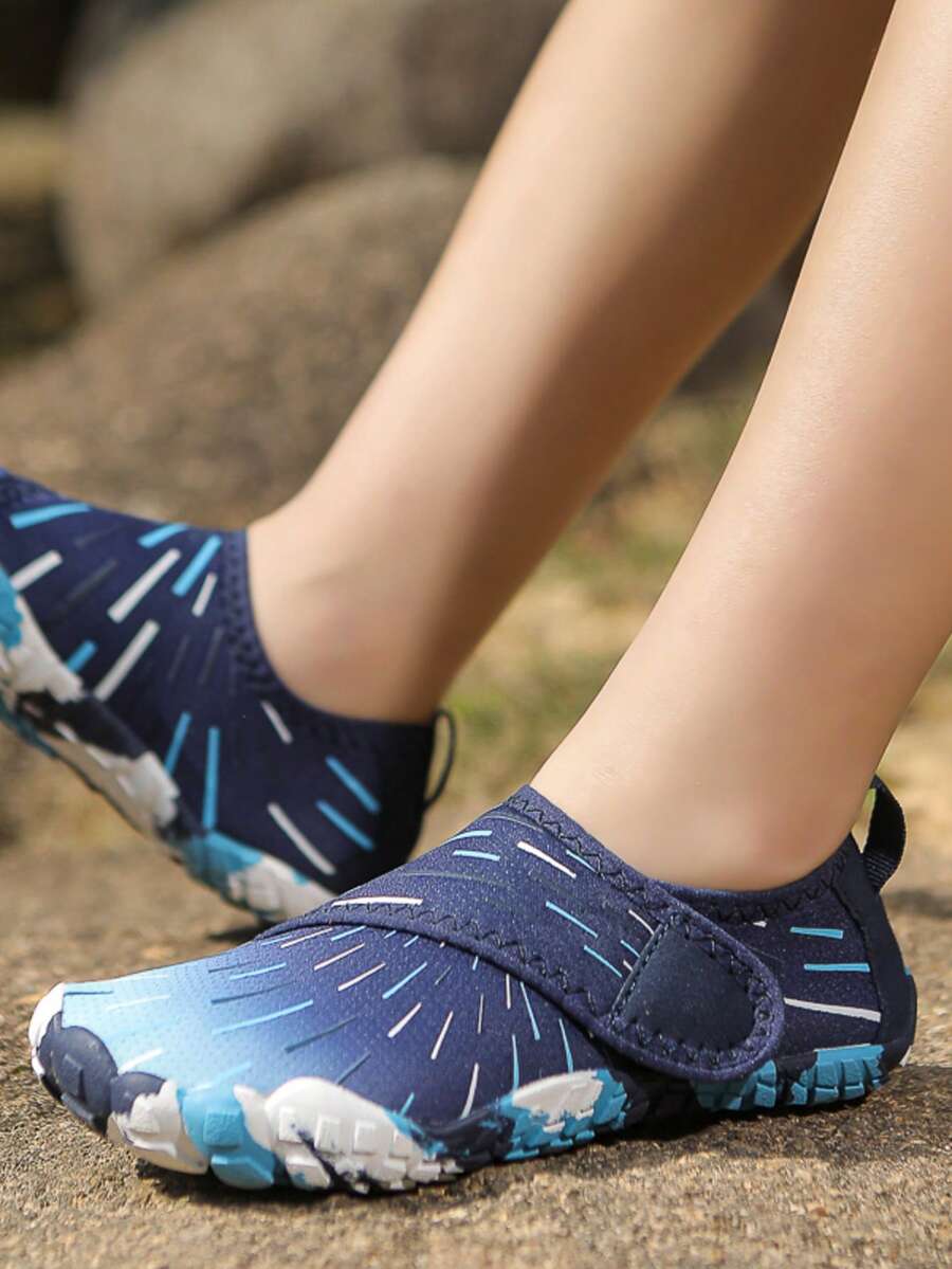 Multicolor kids water shoes with breathable mesh upper, luminous accents, and durable rubber sole with hook and loop closure.