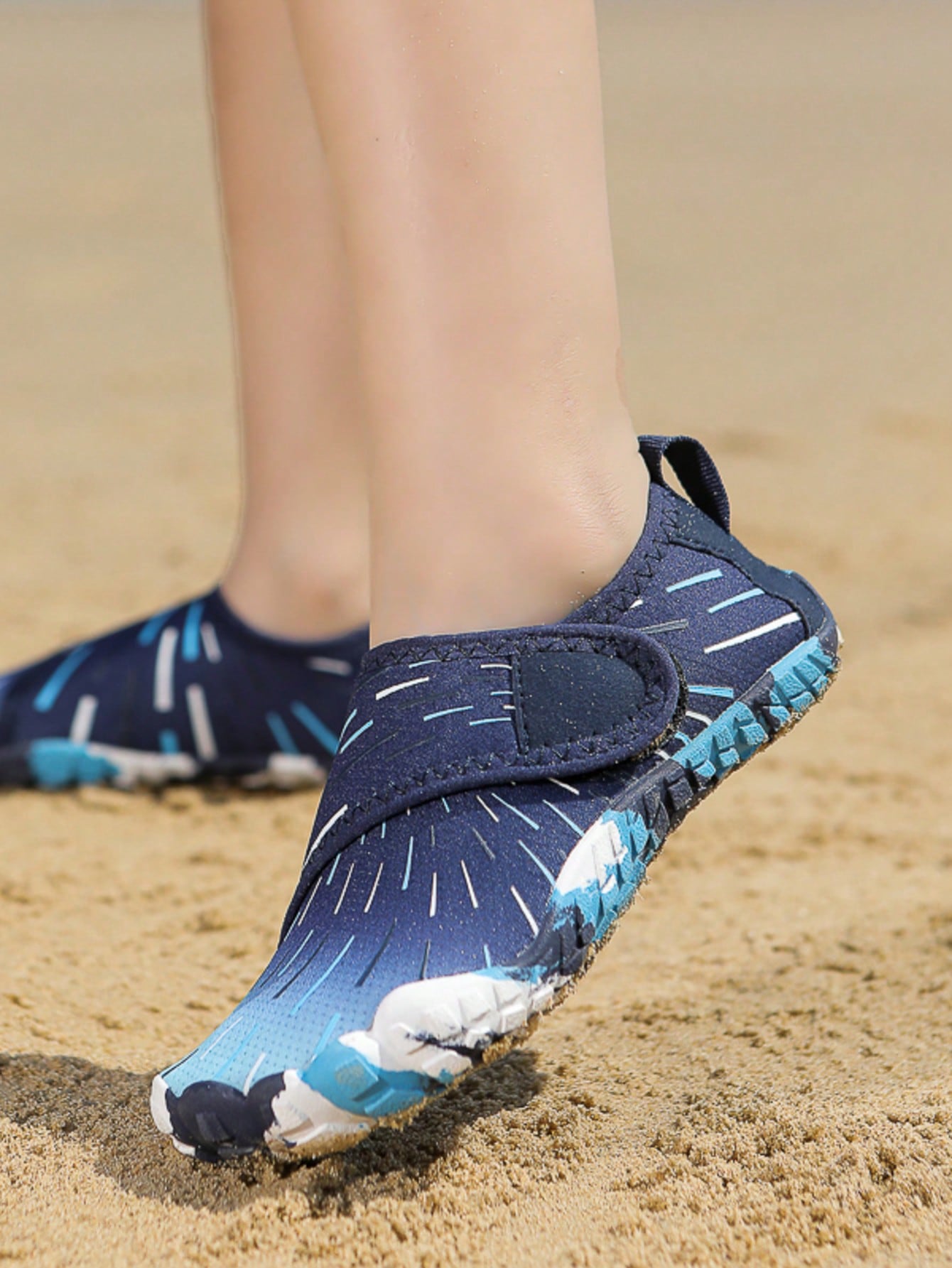Multicolor kids water shoes with breathable mesh upper, luminous accents, and durable rubber sole with hook and loop closure.
