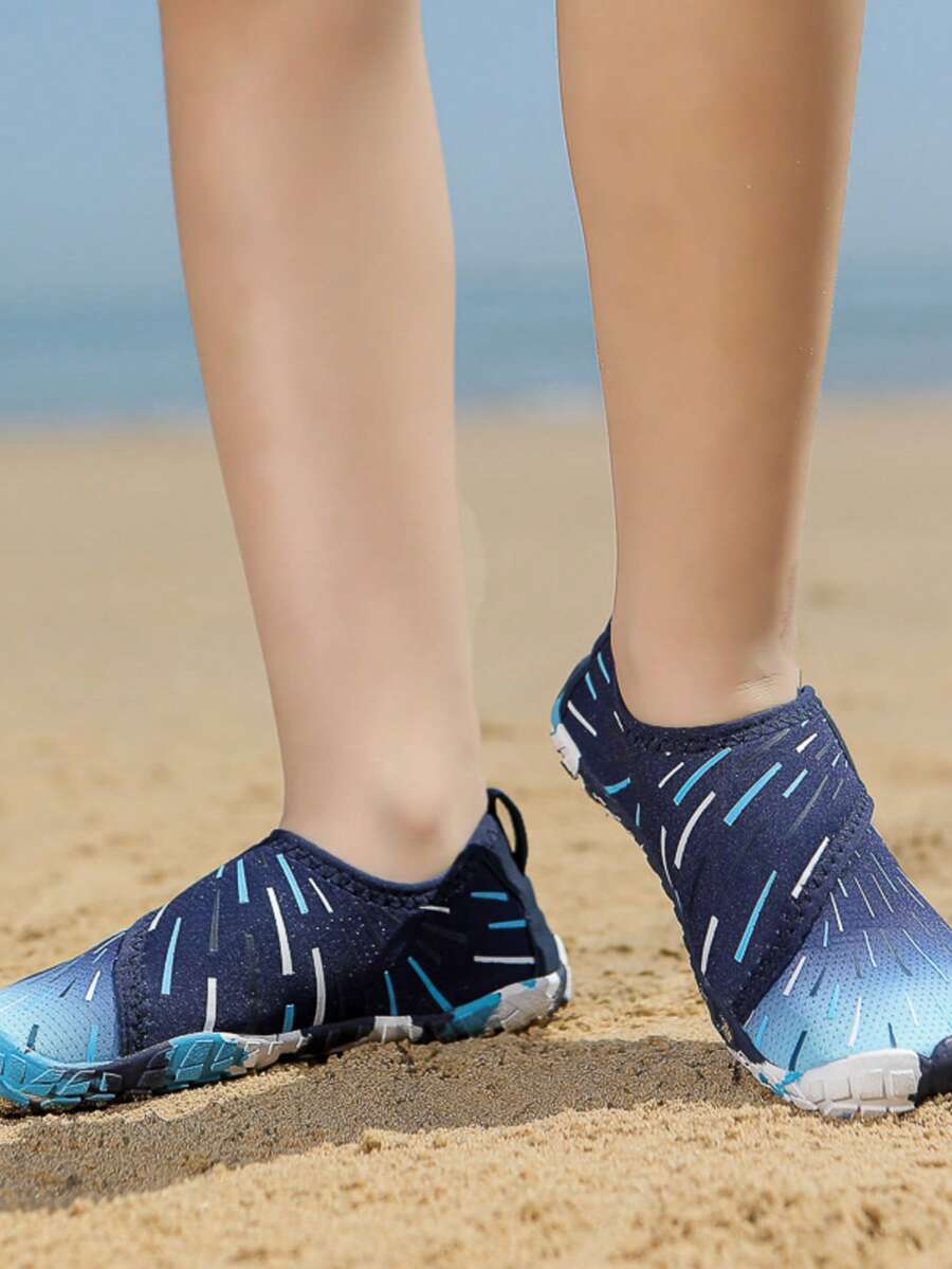 Multicolor kids water shoes with breathable mesh upper, luminous accents, and durable rubber sole with hook and loop closure.