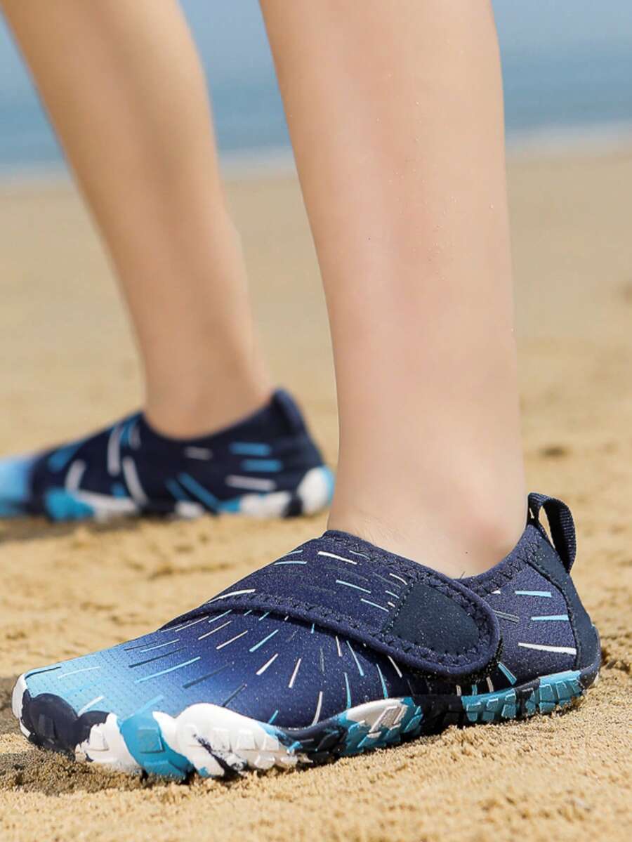 Multicolor kids water shoes with breathable mesh upper, luminous accents, and durable rubber sole with hook and loop closure.
