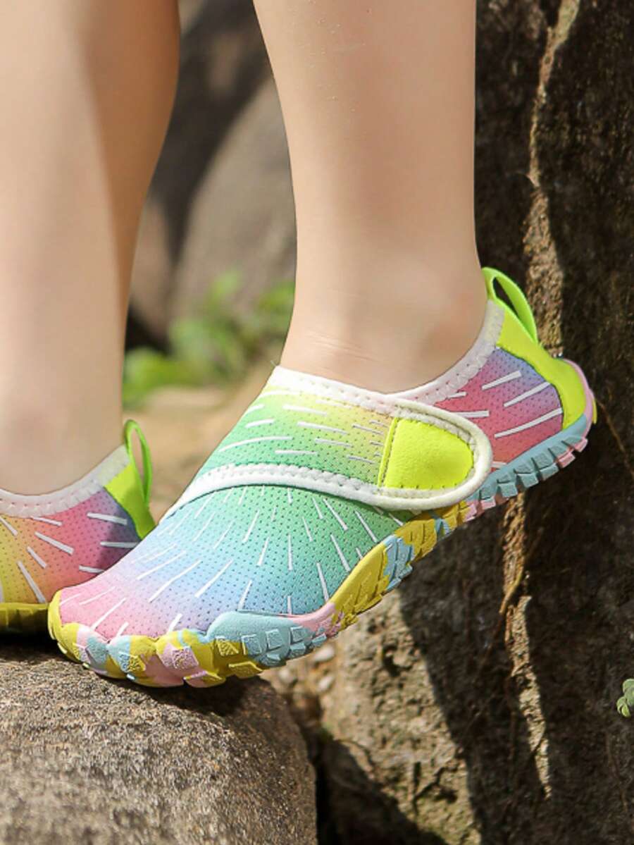 Multicolor kids water shoes with breathable mesh upper, luminous accents, and durable rubber sole with hook and loop closure.