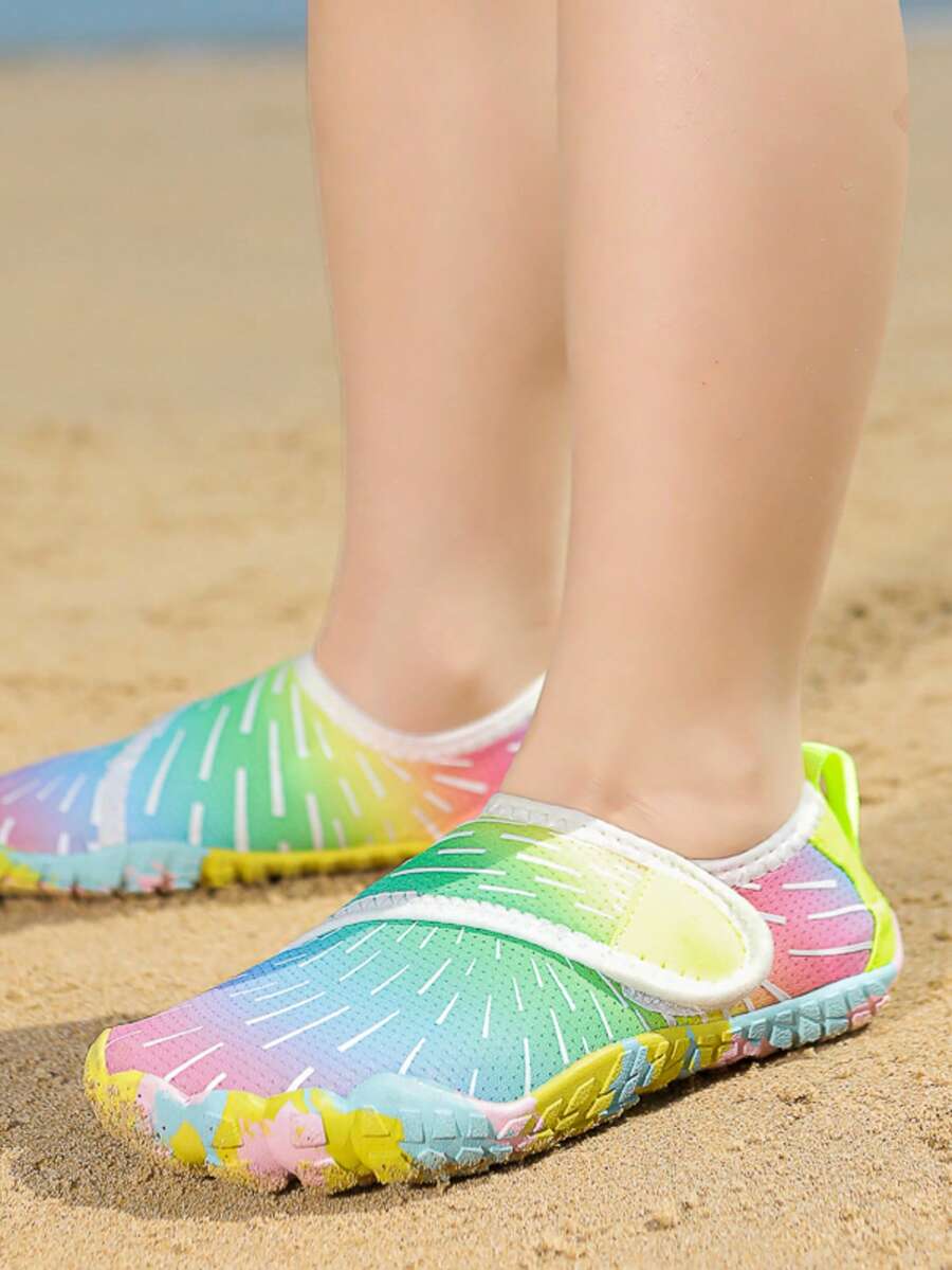 Multicolor kids water shoes with breathable mesh upper, luminous accents, and durable rubber sole with hook and loop closure.