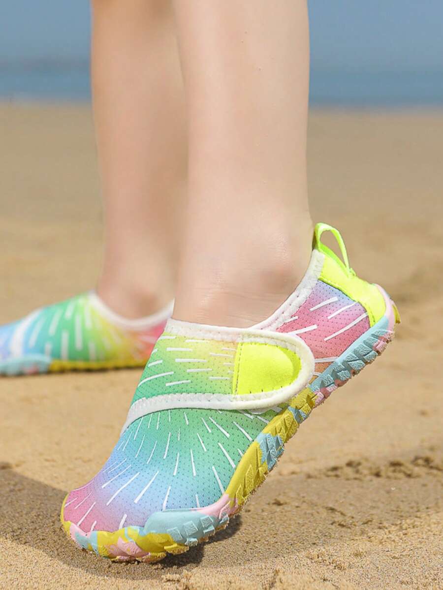 Multicolor kids water shoes with breathable mesh upper, luminous accents, and durable rubber sole with hook and loop closure.