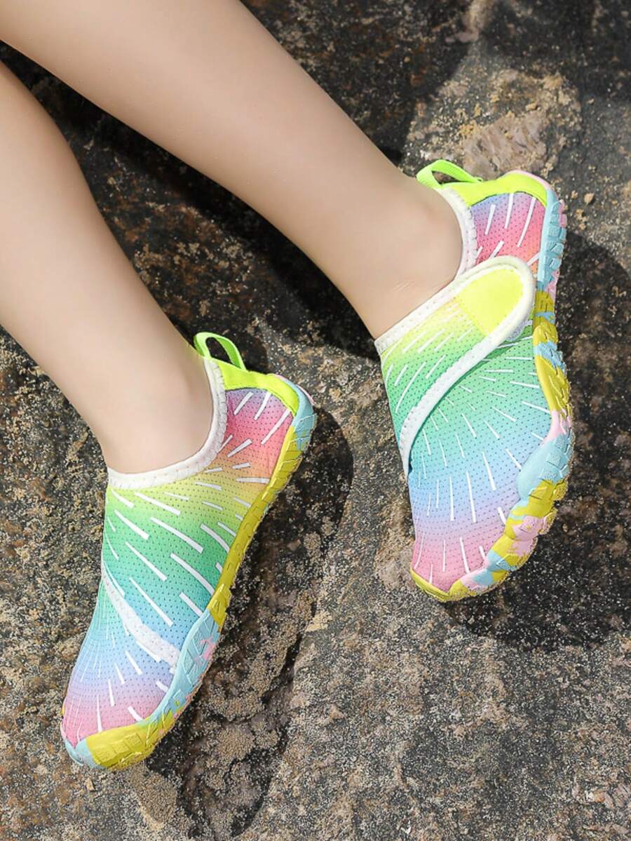 Multicolor kids water shoes with breathable mesh upper, luminous accents, and durable rubber sole with hook and loop closure.