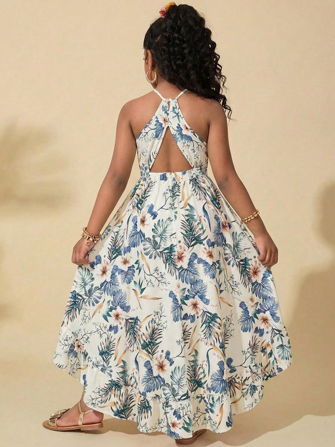 Apricot tween girls sleeveless halter dress with floral plant print, cut-out detail, high waist, and long flared hem for vacation or holiday outfits