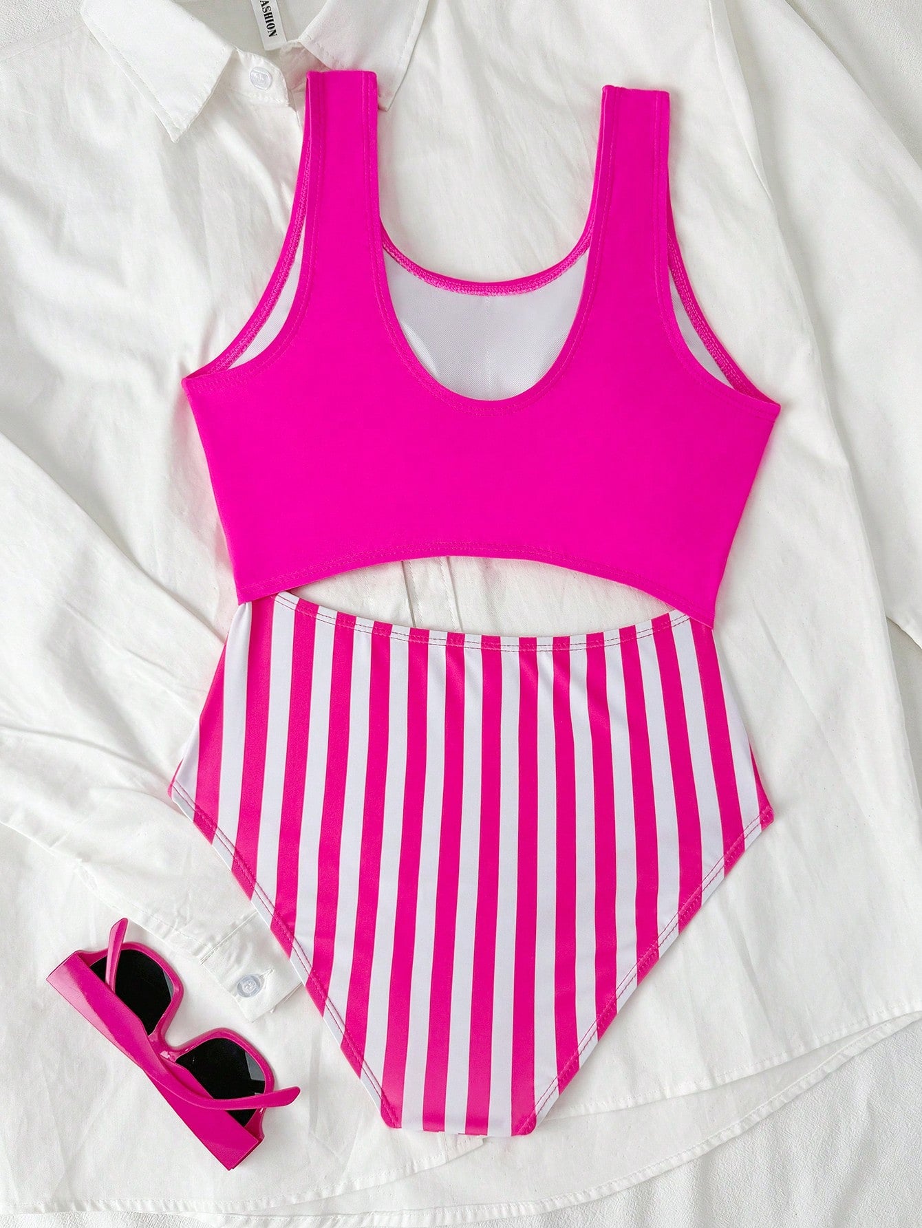 Purple tween girls one-piece swimsuit with asymmetrical neckline, cut-out waist, striped pattern, fitted silhouette, and lined body.