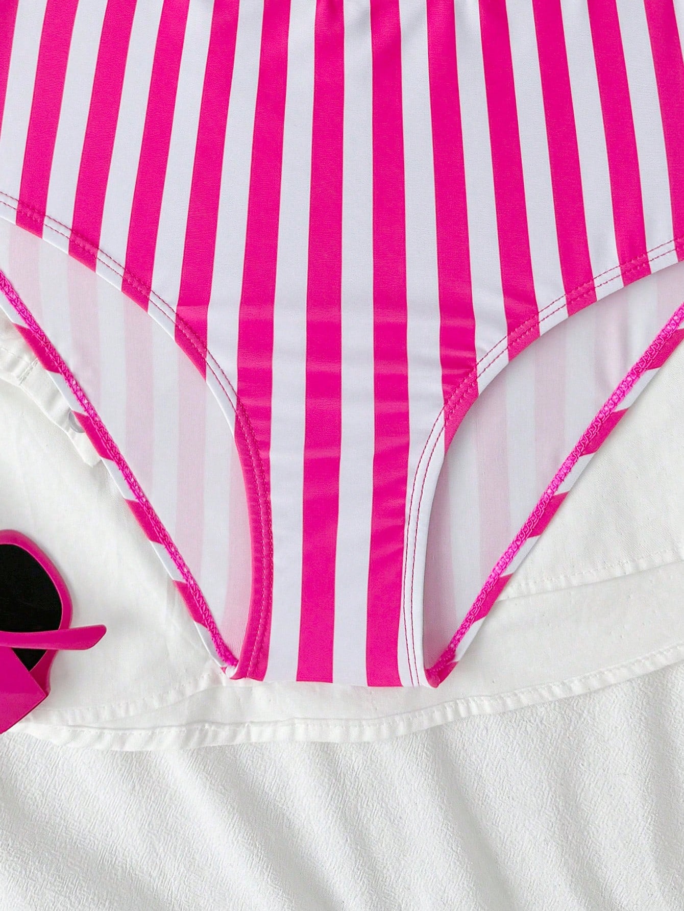 Purple tween girls one-piece swimsuit with asymmetrical neckline, cut-out waist, striped pattern, fitted silhouette, and lined body.